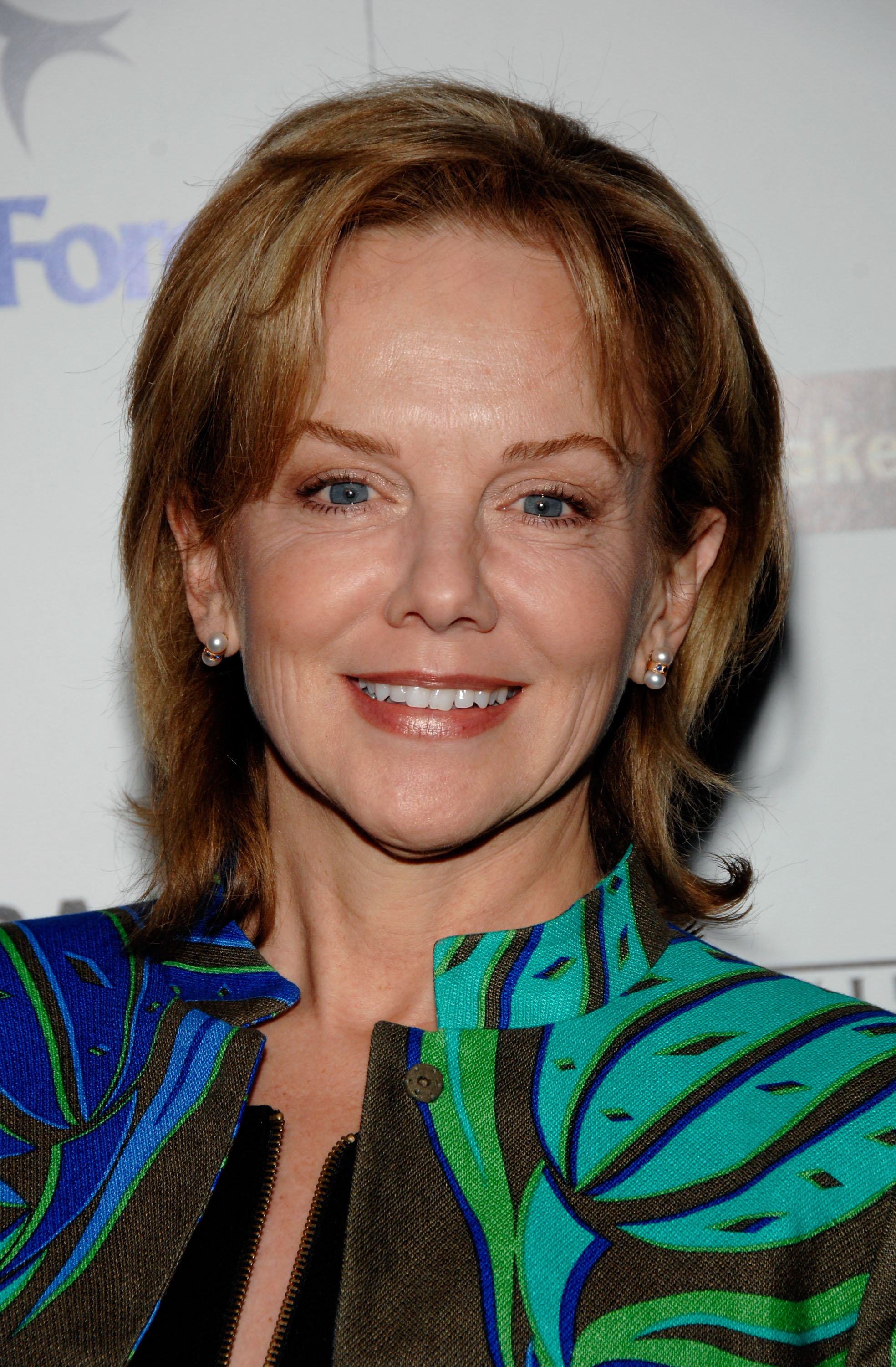 Vibrant swirls of electric teal and cobalt adorned 53-year-old Linda Purl at the Second Annual Douglas Blasdell Outreach Program Celebration on March 11, 2009, at Bardot in Los Angeles. Her warm expression and delicate pearl studs brought forward a naturally mature beauty, underscored by gentle laugh lines and a feathered, honey-brown shag cut.