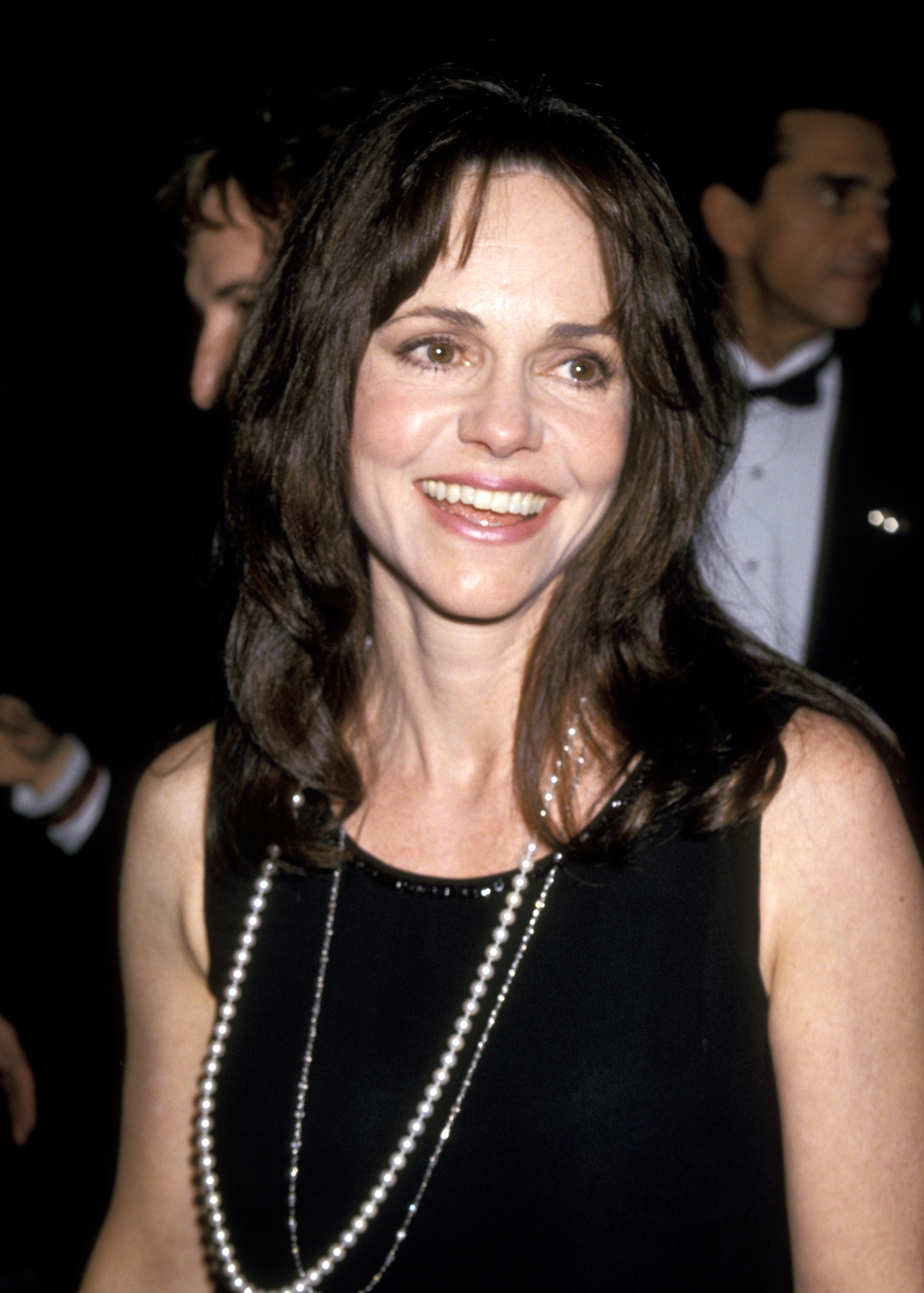 Sally Field at the American Film Institute's tribute to Steven Spielberg at the Beverly Hilton Hotel in Beverly Hills. She wears a black dress paired with a pearl necklace, smiling warmly at the camera, her cheeks now more defined compared to her younger years.