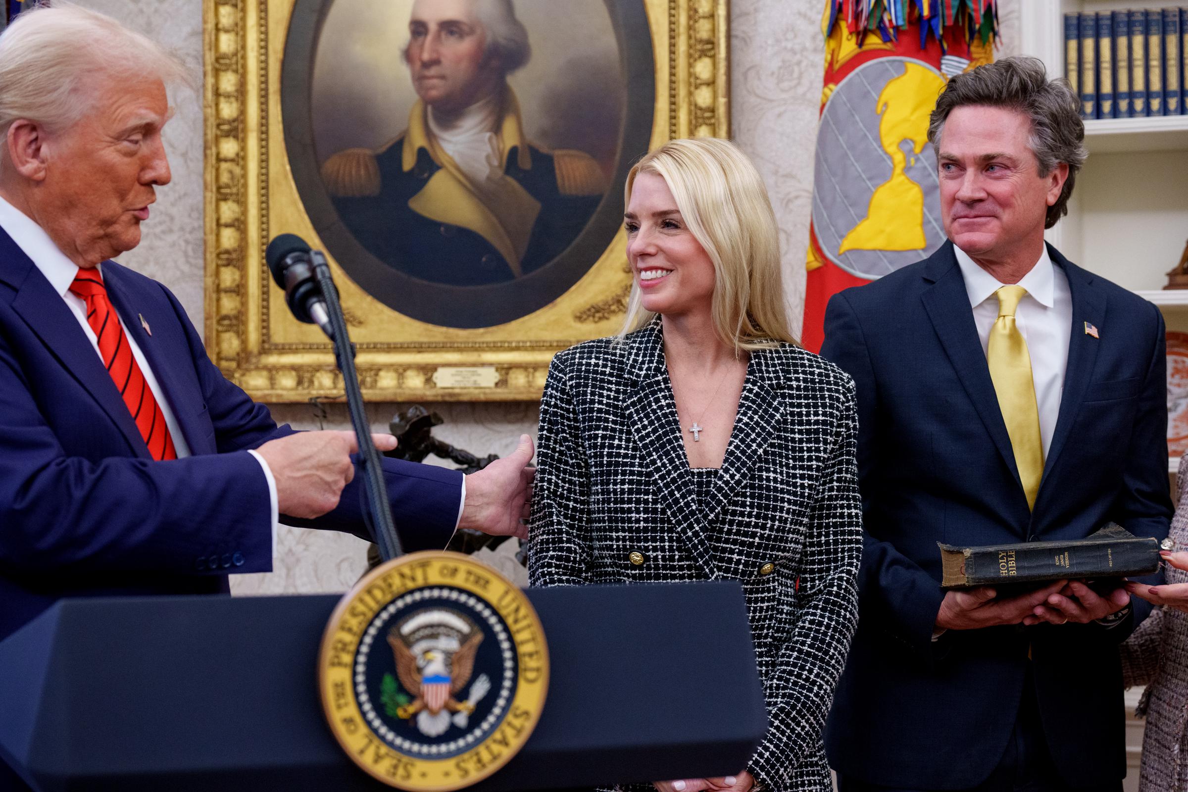 Donald Trump congratulates Pam Bondi as John Wakefield stands beside her | Source: Getty Images