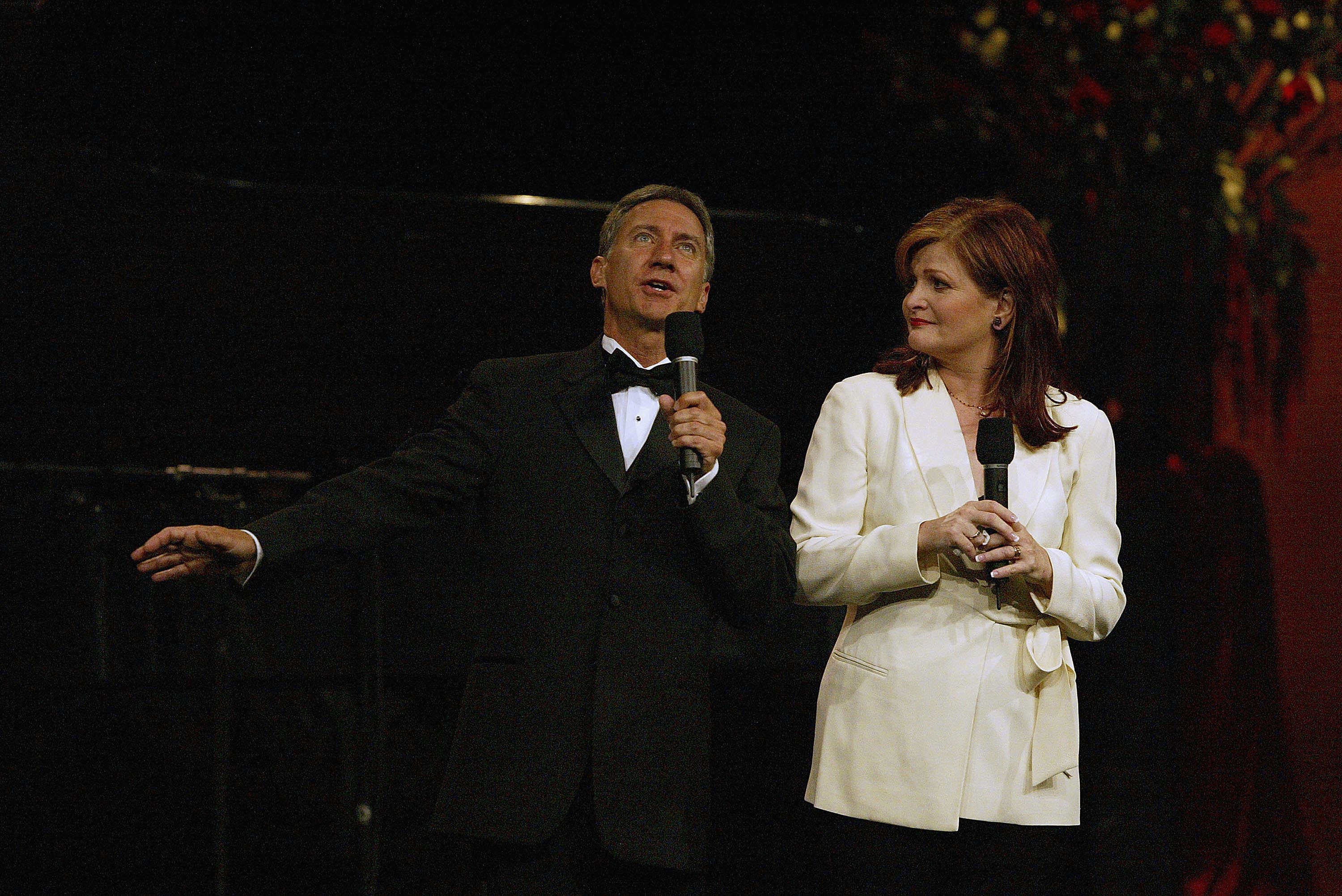 David Garrison and Faith Prince commanded the stage with microphones in hand while performing during the Television Critics Association Press Tour at the Westin Century Plaza Hotel on July 8, 2004, in Century City, California. The musical performers looked sophisticated under the stage lights, with Garrison dressed in a formal black tuxedo and bow tie, while Prince stood alongside him in a chic belted ivory wrap jacket and dark trousers. | Source: Getty Images