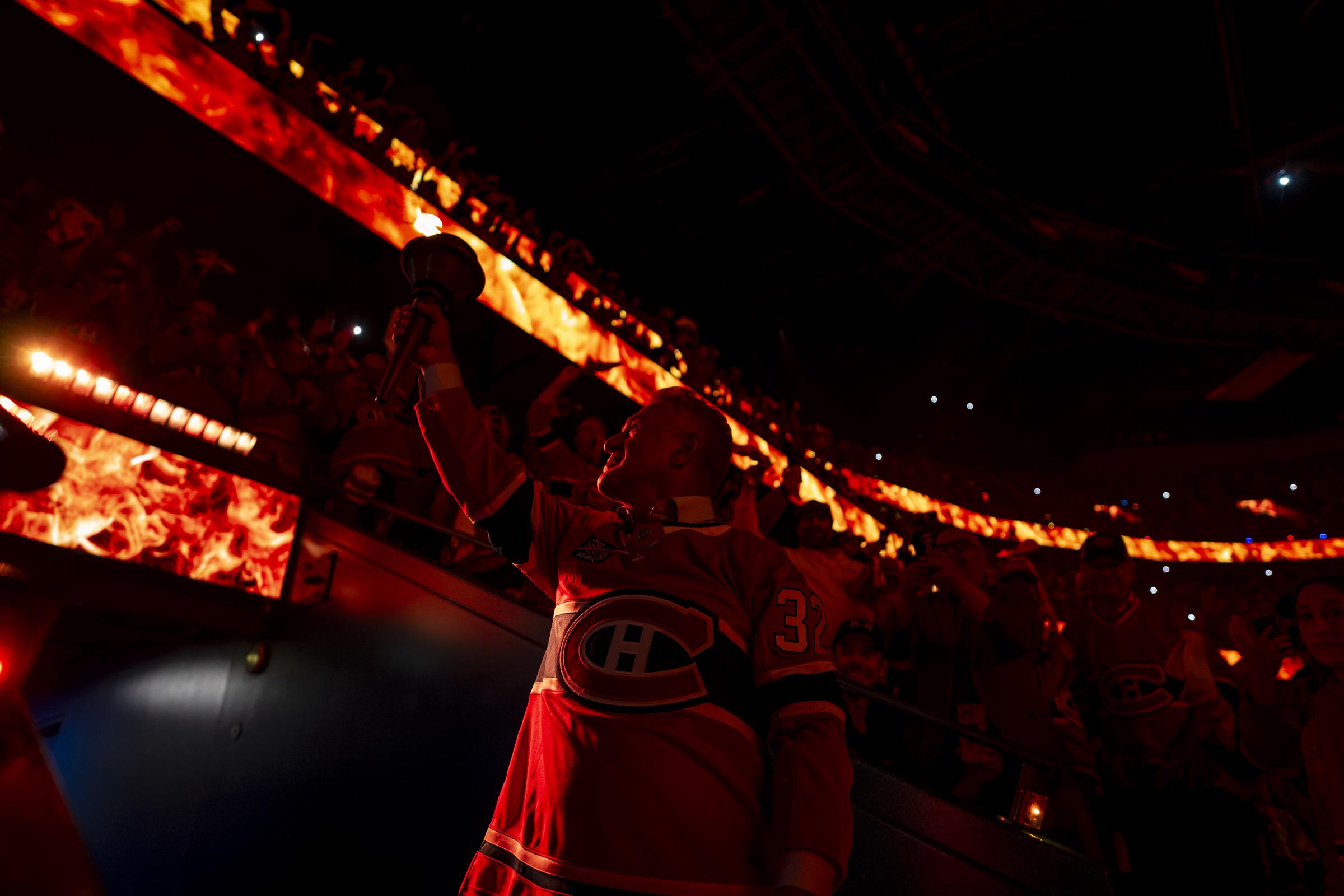 Claude Lemieux carries the torch in the opening ceremony of Game Three of the Eastern Conference Final of the 2026 Stanley Cup Playoffs. | Source: Getty Images