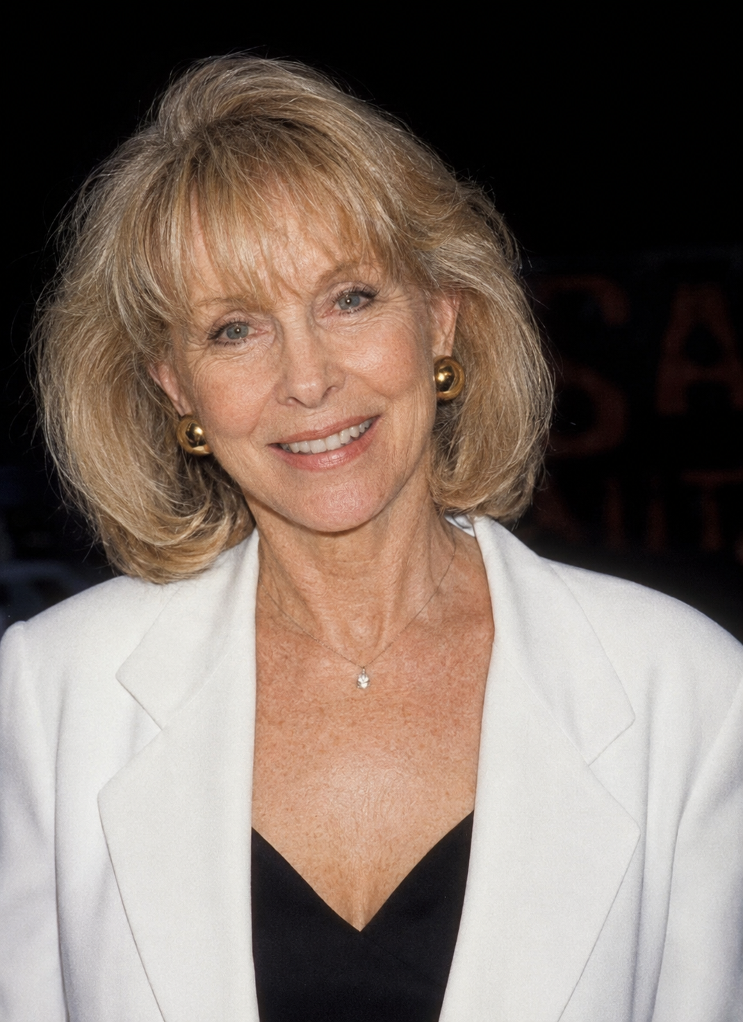 A computer-generated portrait depicts Barbara Eden with naturally aged facial features, including softer cheeks and more defined expression lines, while maintaining her recognizable smile. | Source: ChatGPT