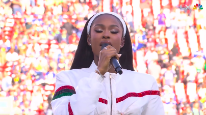 Coco Jones singing to the audience during the sports event. | Source: Facebook/Essence