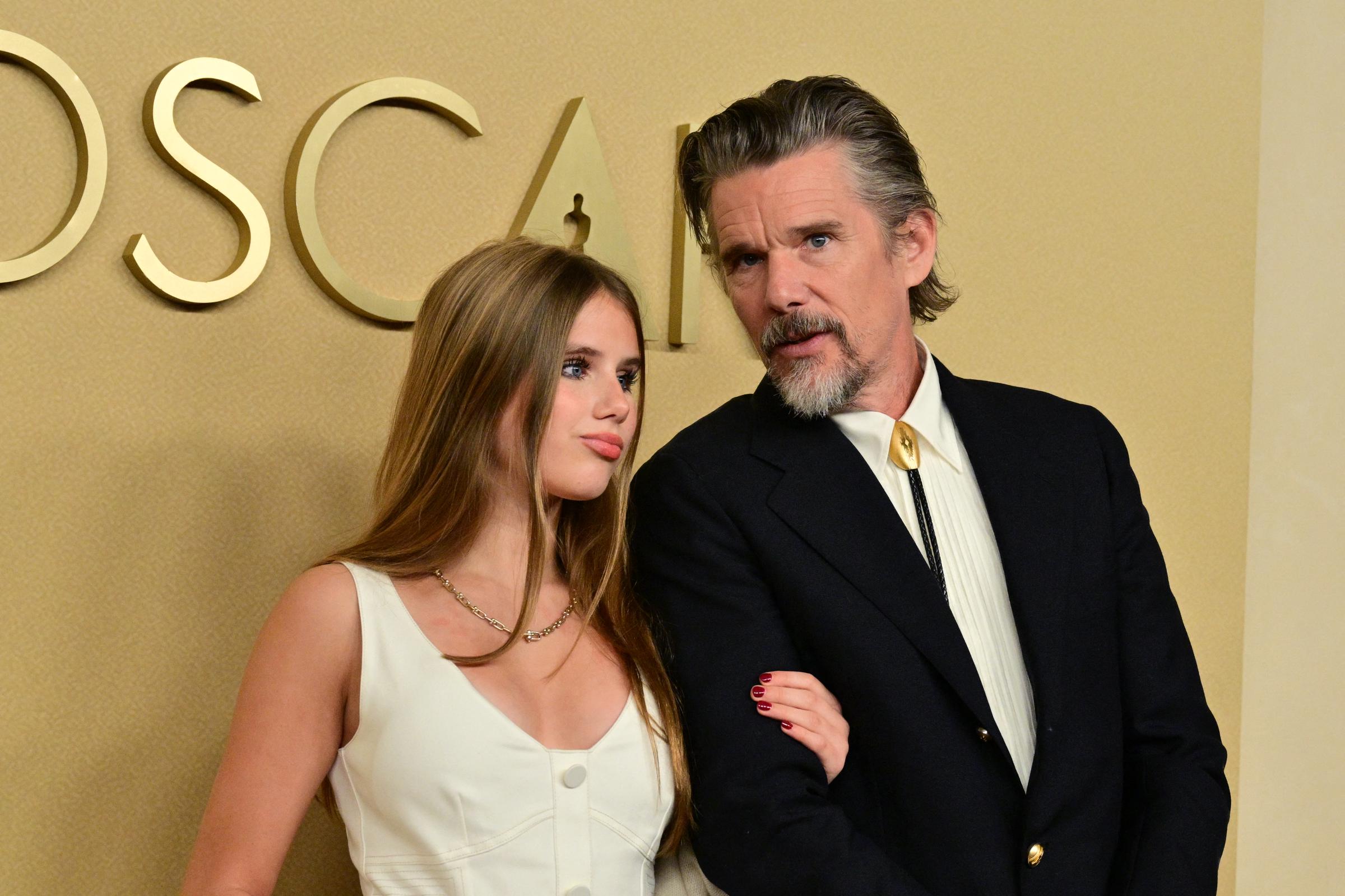 Ethan Hawke converses with his daughter at the 98th Oscar Nominees Luncheon at The Beverly Hilton on February 10, 2026 in California. | Source: Getty Images