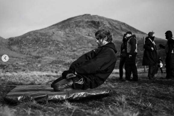 Away from the gym, Alexander Skarsgård rested between takes while filming "The Northman" outdoors, offering a quieter behind-the-scenes glimpse of the demanding production. | Source: Instagram/aidanmonaghanphotographer