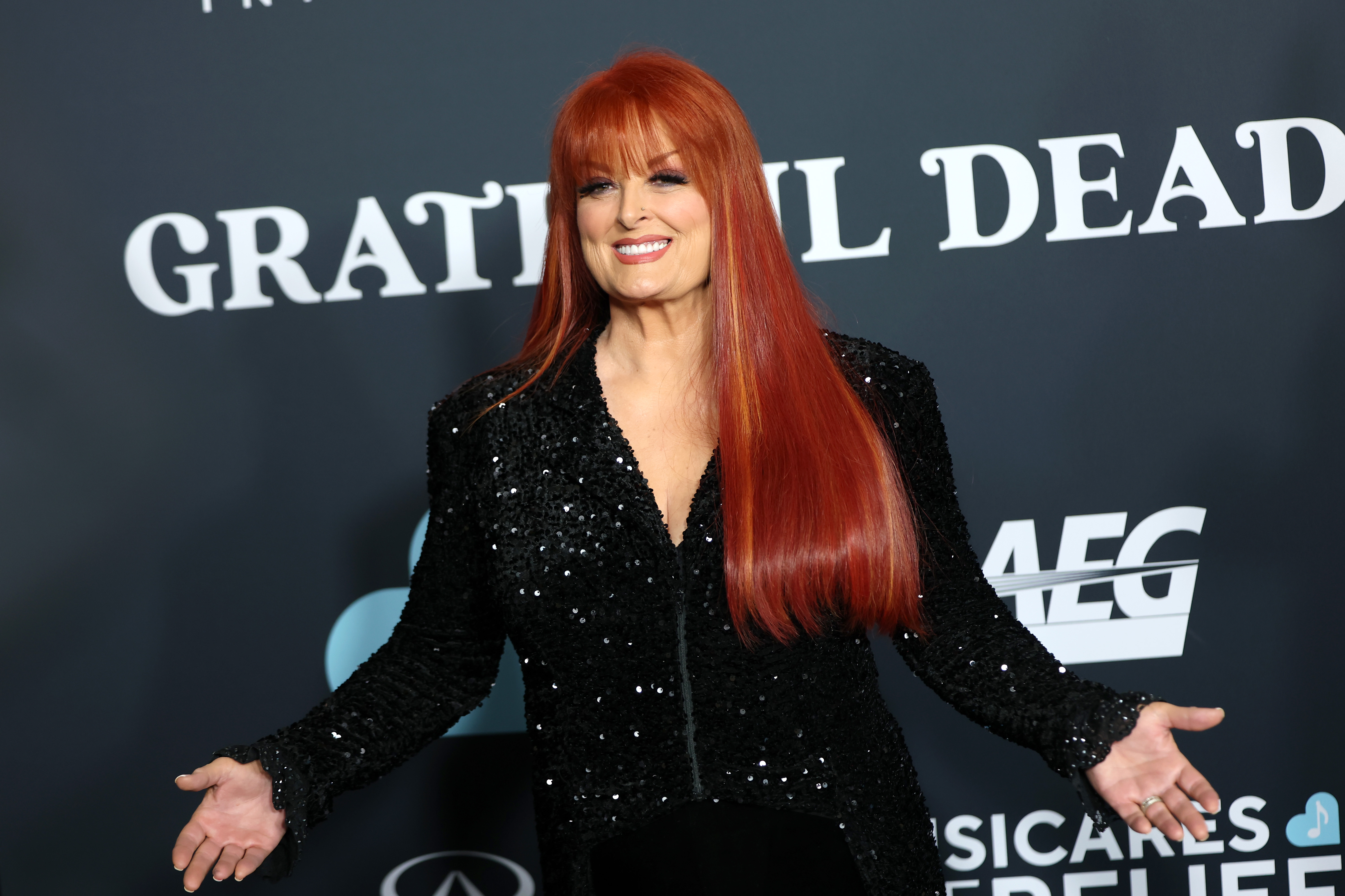 Wynonna smiles for photographers at the MusiCares Persons of the Year event in Los Angeles on January 31, 2025. Dressed in a sparkling black outfit, she was attending an event honoring the Grateful Dead, years after making Leiper's Fork her home. | Source:  Getty Images