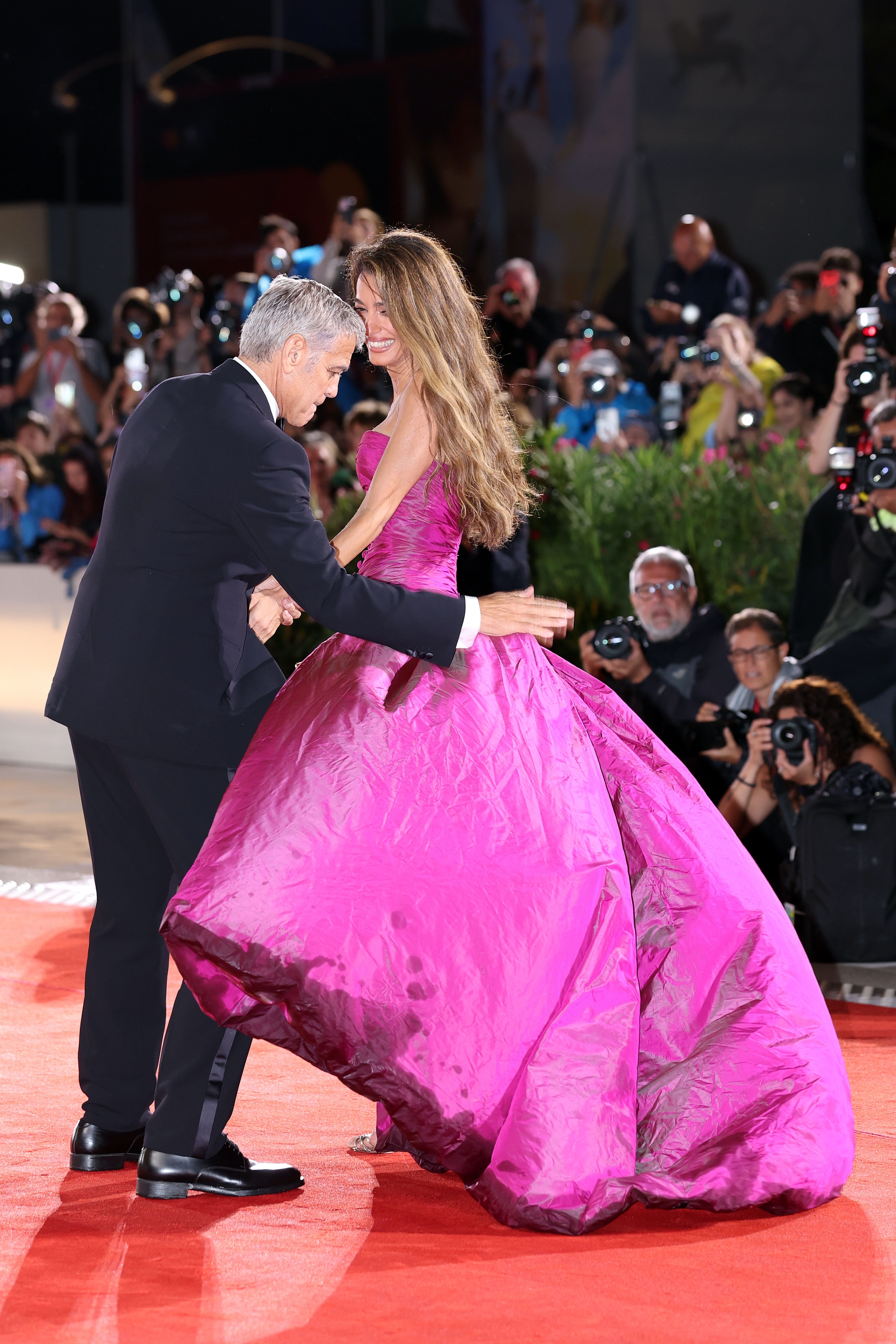 Amal Clooney's dress gets wet at the "Jay Kelly" red carpet at the Venice International Film Festival in Italy on August 28, 2025 | Source: Getty Images