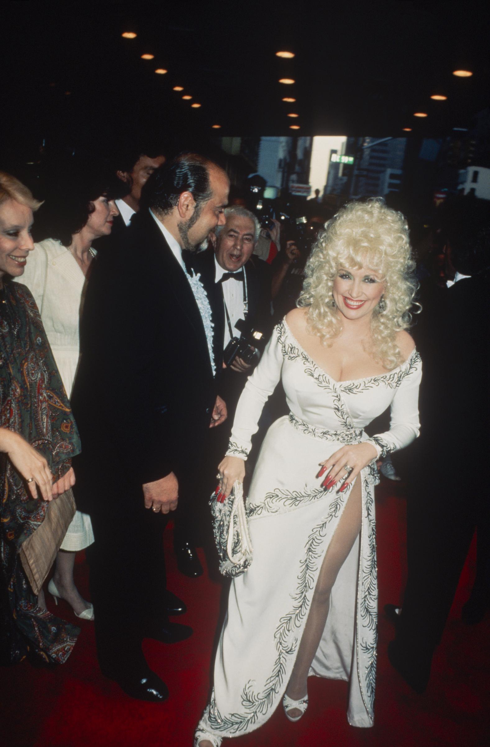 Dolly Parton wearing a white beaded dress at a formal event, New York.
