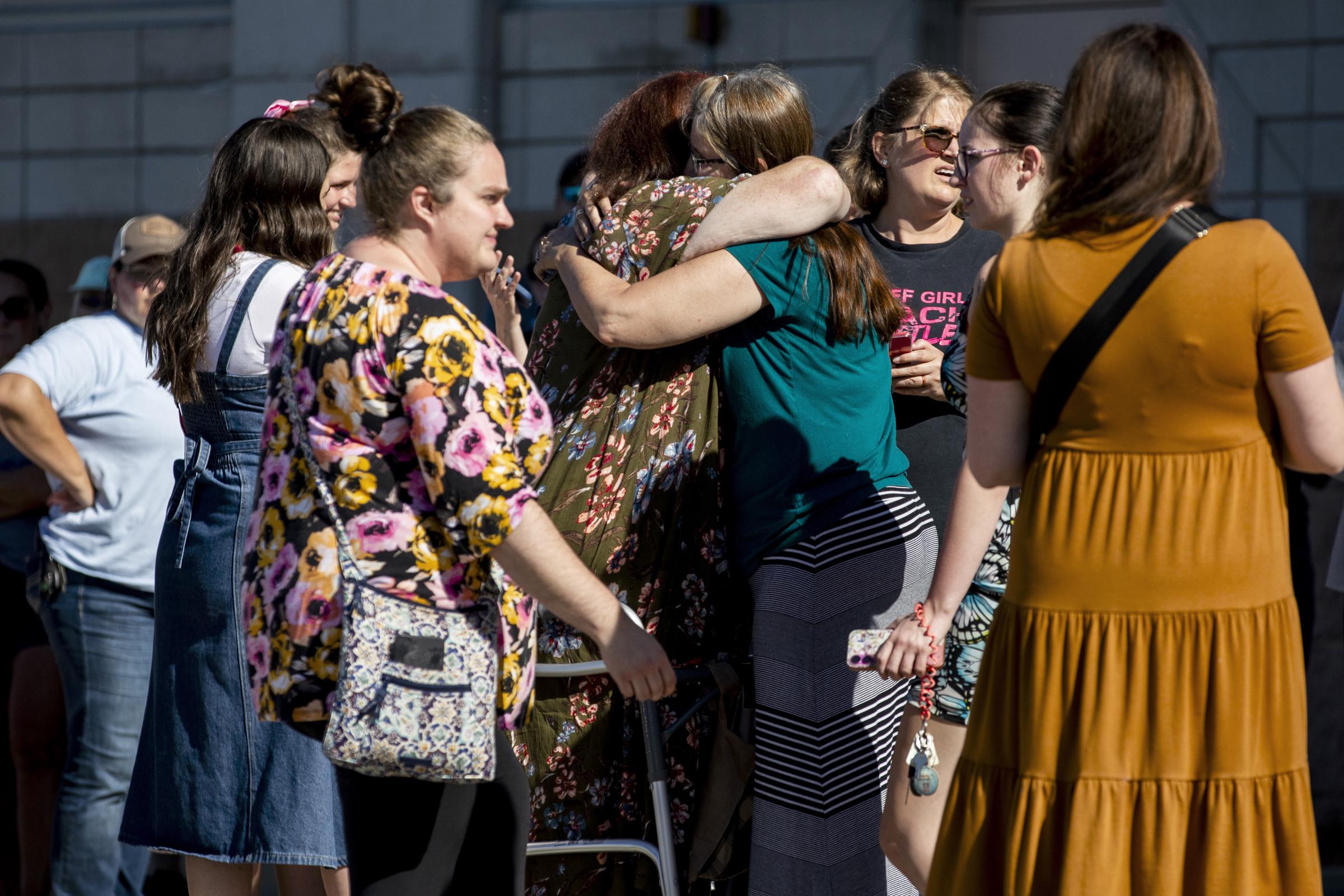 Church members and residents reunite at Trillium Theater located across the street from the site of a shooting and fire at the Church of Jesus Christ of Latter-day Saints on September 28, 2025, in Grand Blanc, Michigan. | Source: Getty Images