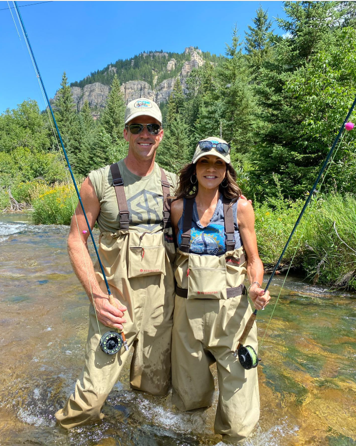 Waders on and rods in hand, Kristin Noem and Bryon Noem tand midstream — partners in both life and the outdoors. | Source: Facebook/KristiNoem