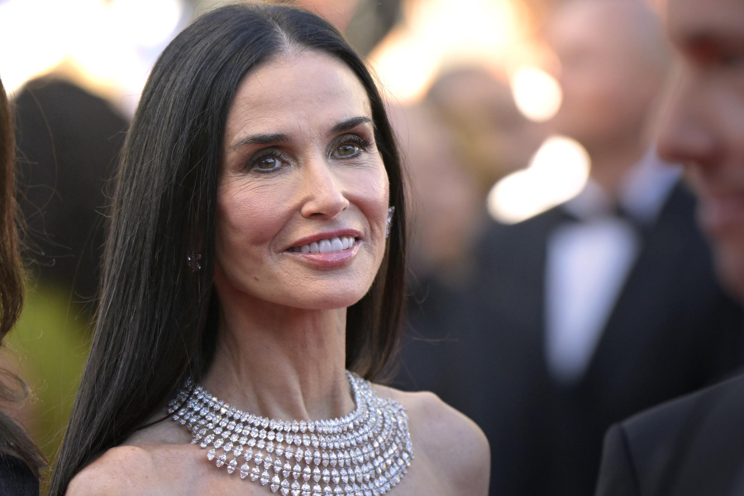A close-up photo captures Demi Moore's polished makeup and statement jewelry at Cannes | Source: Getty Images