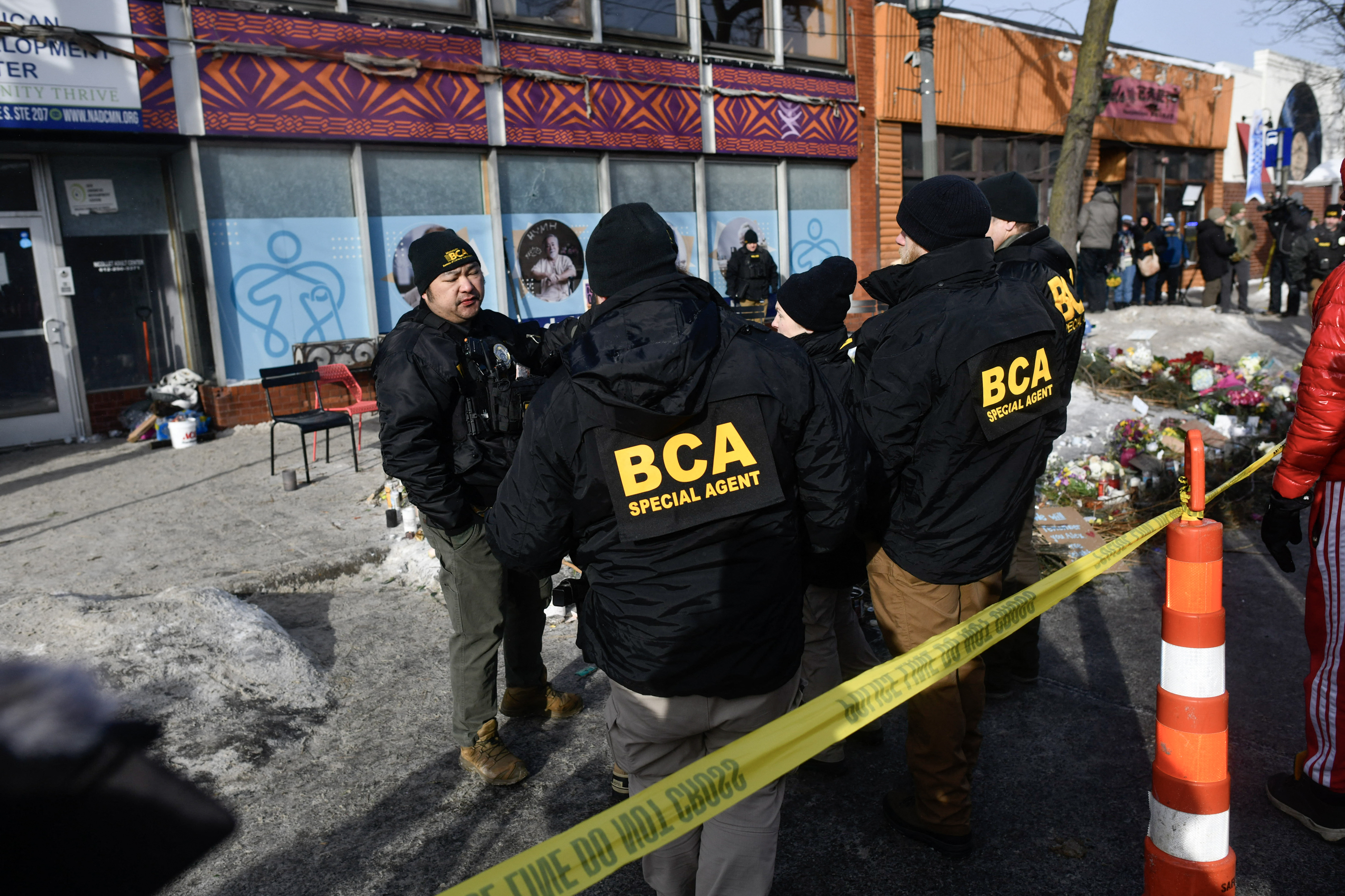Bureau of Criminal Apprehension police officers survey the scene near a makeshift memorial in the area where Alex Pretti was shot a day earlier by federal immigration agents on January 25, 2026, in Minneapolis, Minnesota | Source: Getty Images