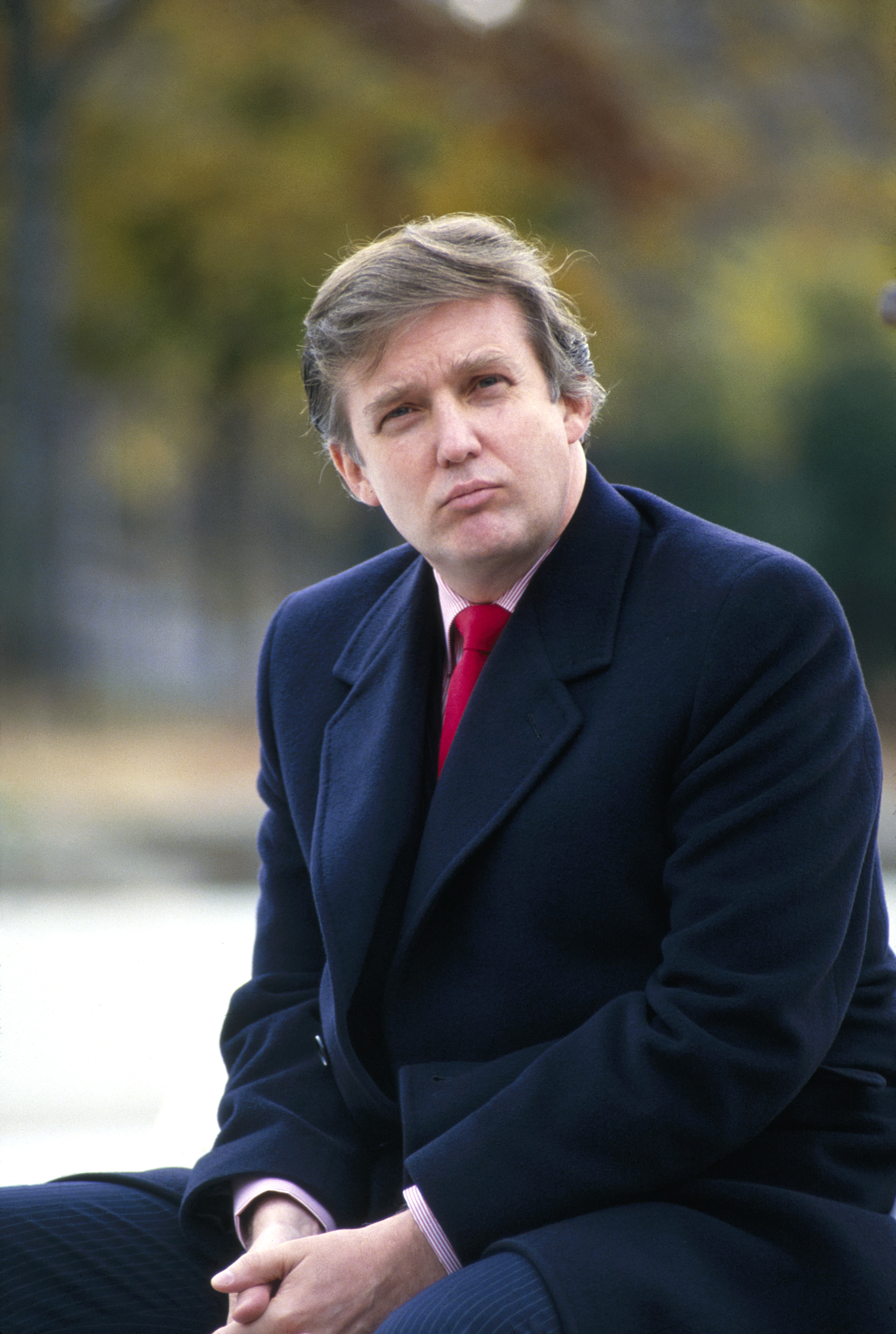 Donald Trump wears his dark hair in a fuller, side-swept style during a portrait session in New York City in 1985.