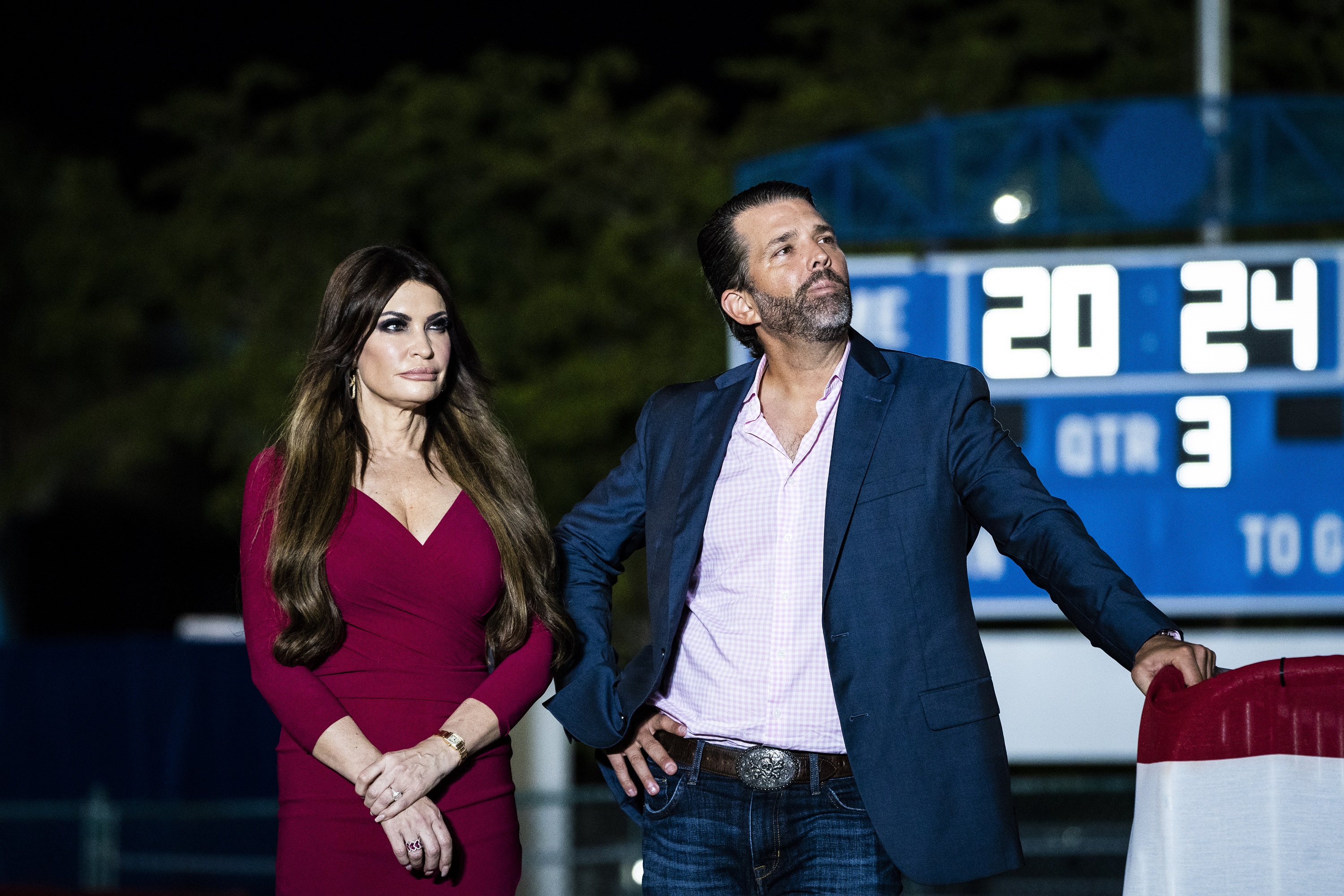 Donald Trump Jr. and Kimberly Guilfoyle listen as former President Donald Trump speaks at a campaign rally on November 8, 2023, in Hialeah, Florida | Source: Getty Images