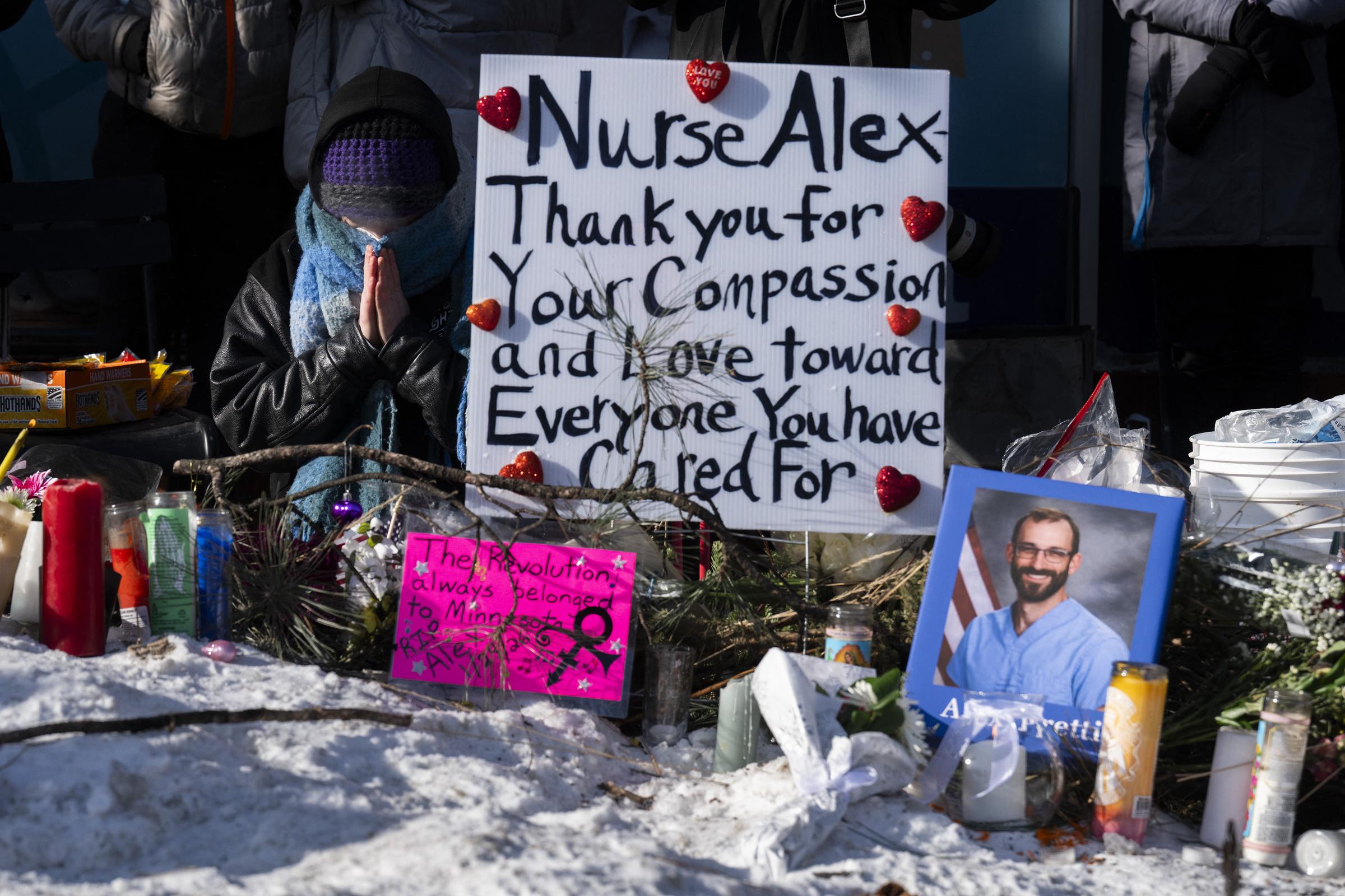A mourner prays as people gather at a makeshift memorial in the area where Alex Pretti was shot a day earlier by federal immigration agents on January 25, 2026, in Minneapolis, Minnesota | Source: Getty Images