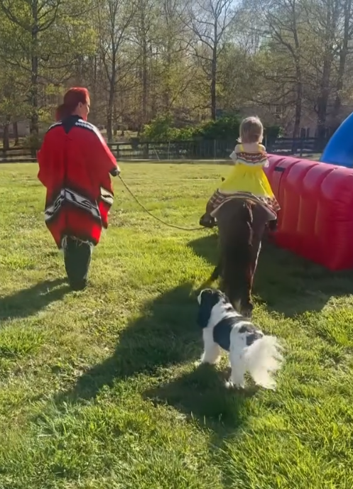 Wynonna walks alongside the pony as Kaliyah rides across the lawn, with a small black-and-white dog following behind. The moment offers a glimpse of the hands-on activities grandmother and granddaughter share away from Wynonna's touring schedule. | Source: Instagram/wynonnajudd