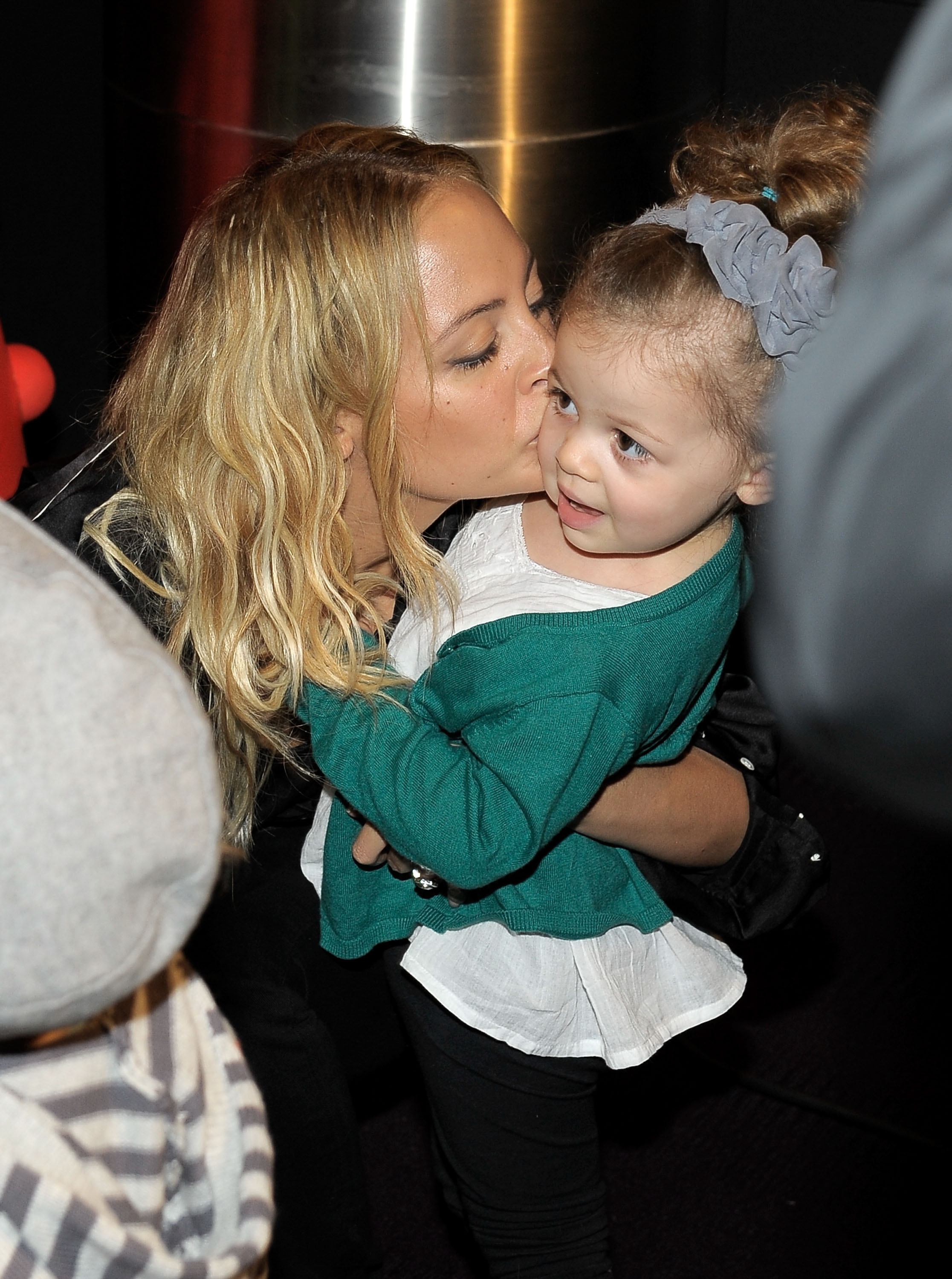 Nicole Richie kisses Harlow Winter Kate Madden on the cheek while holding her at a Yo Gabba Gabba! Live event in Los Angeles in November 2010. Kate wears a green cardigan and looks off to the side as mother and daughter share a sweet moment.