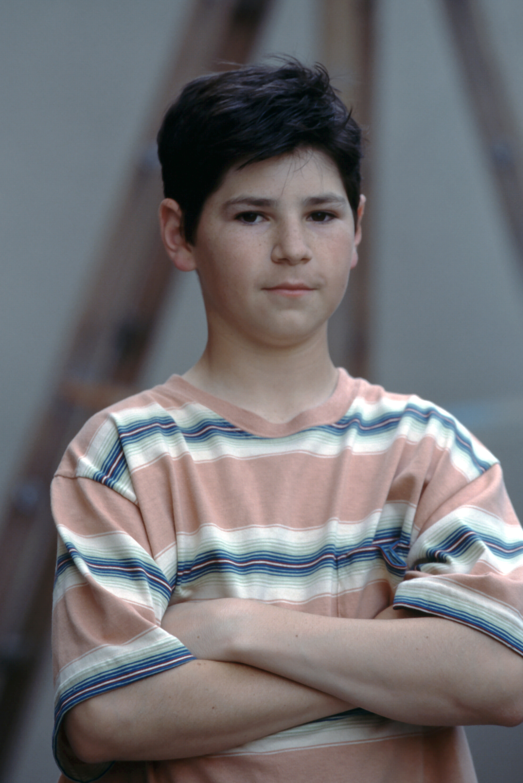The former child star posted an emotional video discussing the cancellation of the "Roseanne" reboot. In this photo, he posed for a portrait on the soundstage lot for "Roseanne" in 1990, in Los Angeles, California. | Source: Getty Images