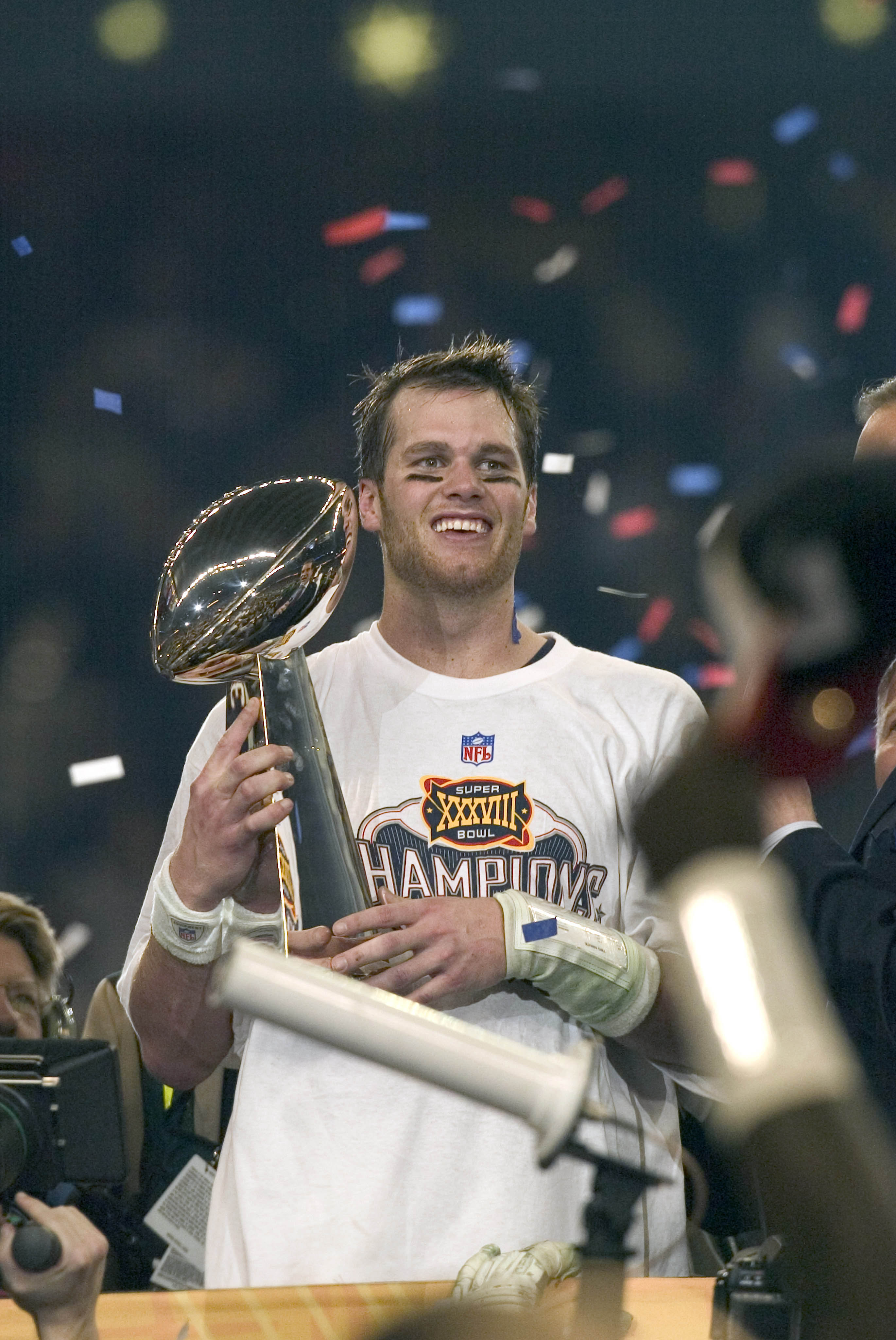Tom Brady celebrated the Patriots' 2003 Super Bowl XXXVIII win while holding the Lombardi Trophy after defeating the Carolina Panthers in Houston.