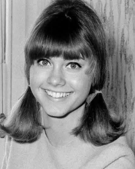 Olivia Newton-John as a teenager. [Photo timeline: 1948 (year she was born) to 1966 (childhood to teenage era)]. | Fun Fact: Olivia made her first film appearance at just 16 in the 1965 Australian musical comedy "Funny Things Happen Down Under." That means her screen career began more than a decade before Sandy Olsson made her a movie superstar in "Grease." | Source: Instagram/therealonj