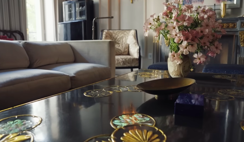The coffee table captures the home's detail-heavy personality in miniature. Even the smaller surfaces are arranged like little scenes. | Source: YouTube/Architectural Digest