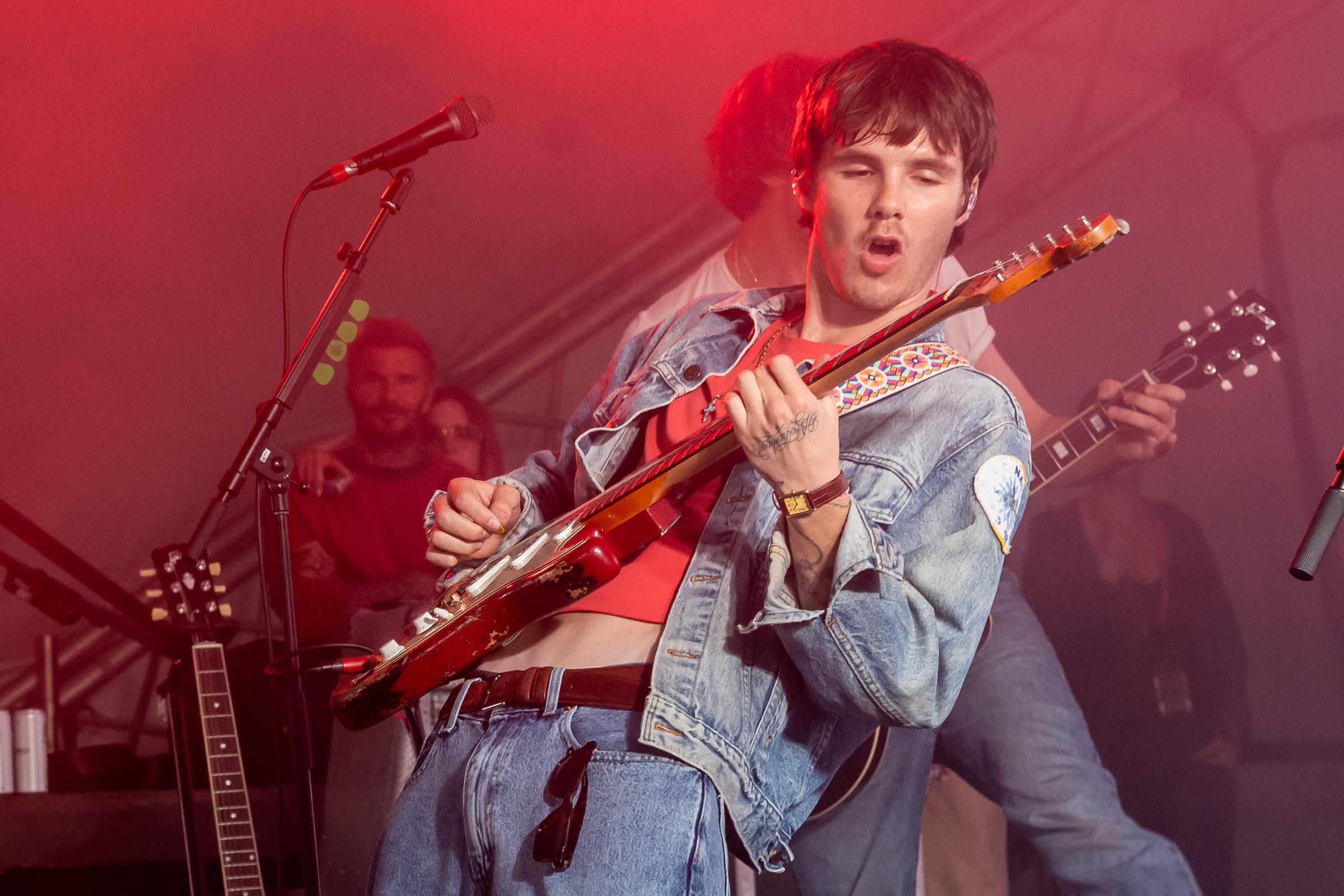 Cruz Beckham took the stage with The Breakers as his family watched from the festival sidelines, marking a significant moment in the 21-year-old's developing music career. | Source: Getty Images