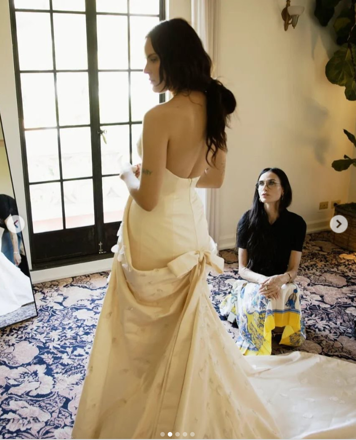 Tallulah Willis gives a first full look at the back of her custom Balenciaga wedding gown, revealing its dramatic open back, sweeping train and oversized bow during her final fitting. | Source: Instagram/vogueweddings