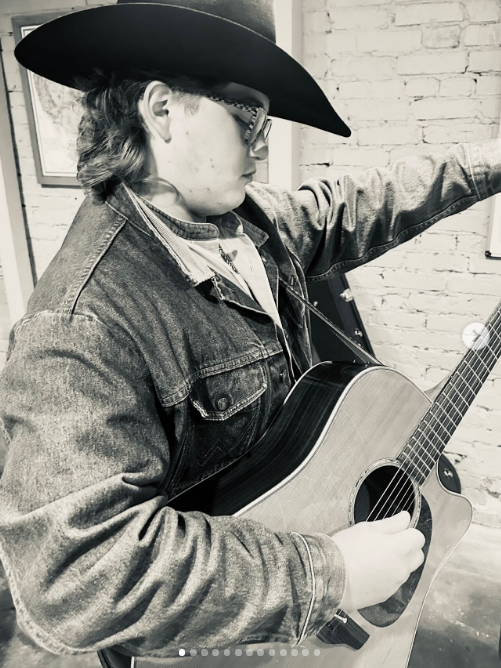 Zuma Rossdale showcased his musical talents while strumming an acoustic guitar in a cowboy hat, glasses, and denim jacket in an image shared on August 21, 2025. | Source: Instagram/gwenstefani