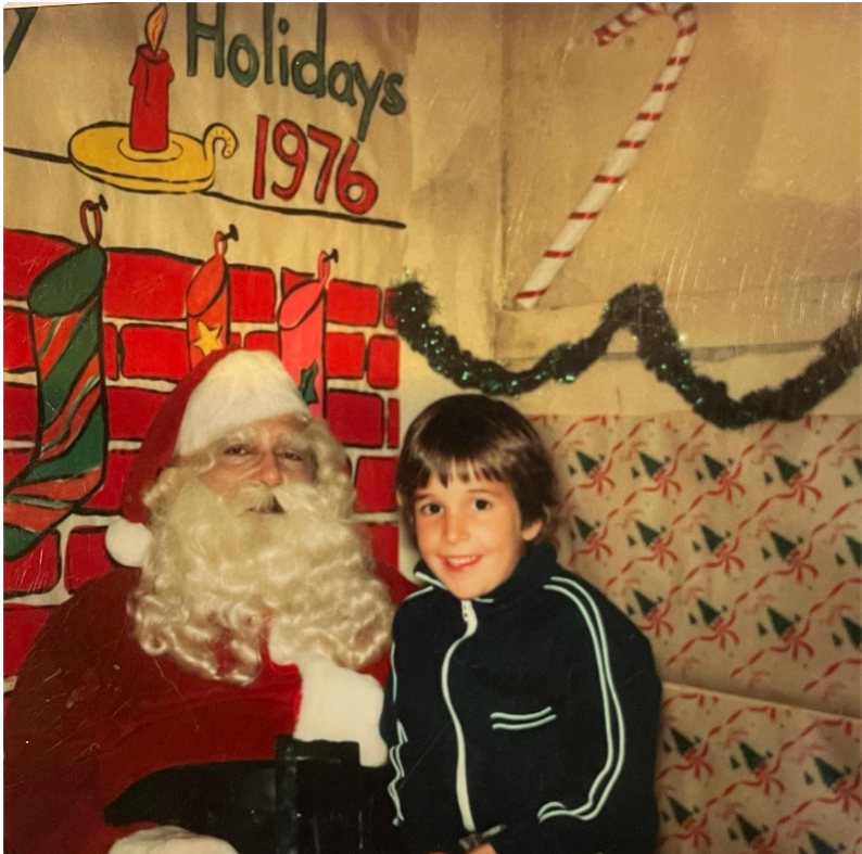 The actor when he was a young boy smiles beside a person dressed as Santa Claus during a 1976 holiday celebration, capturing a sweet childhood memory. | Source: Instagram/therealnoahwyle
