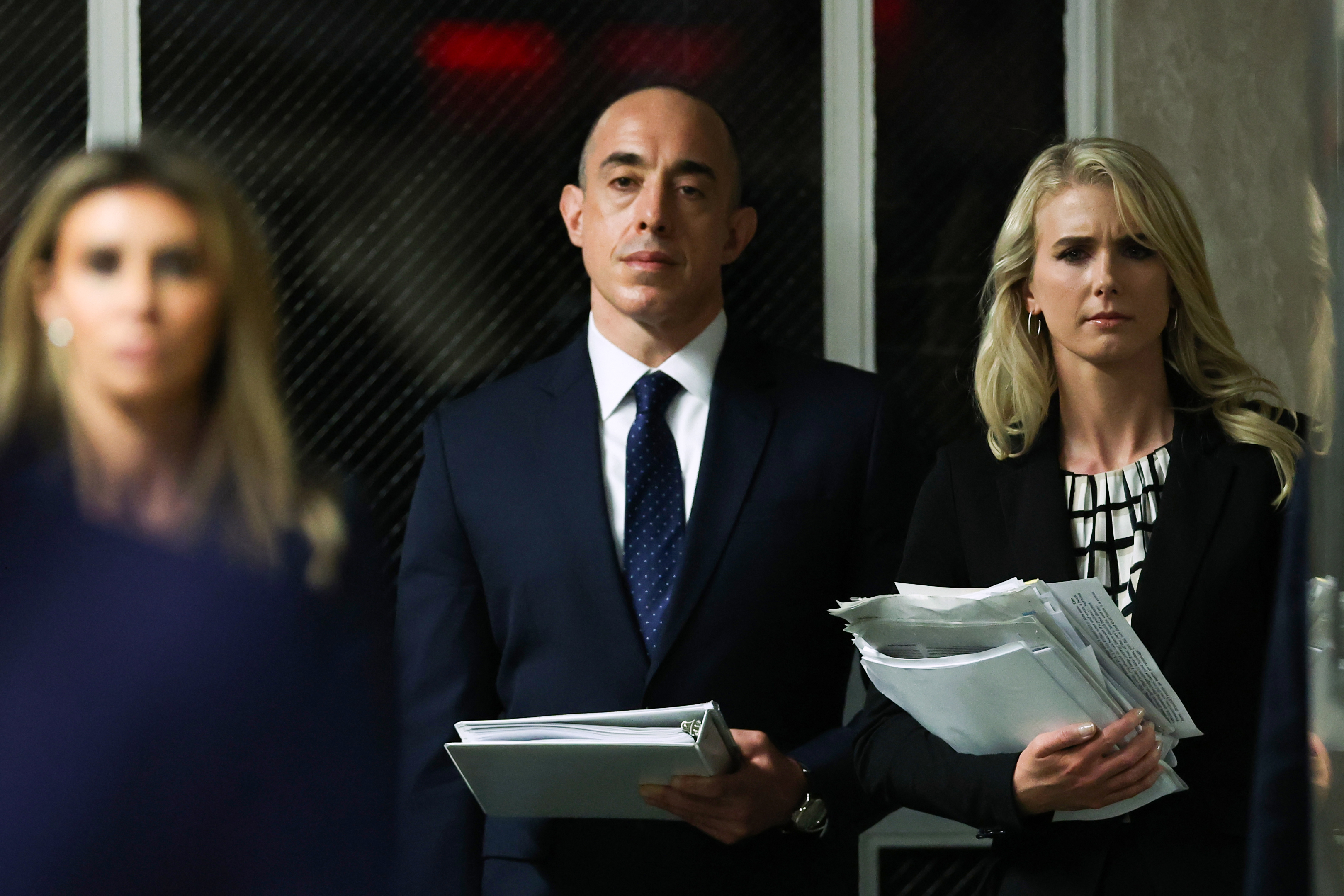 Natalie Harp is pictured carrying a stack of documents, reflecting the role that helped make her a constant presence around Donald Trump and earned her the nickname "Human Printer." Her proximity reportedly extended from the president’s work to his golf outings and even the campaign’s so-called "Ghost Flight." | Source: Getty Images