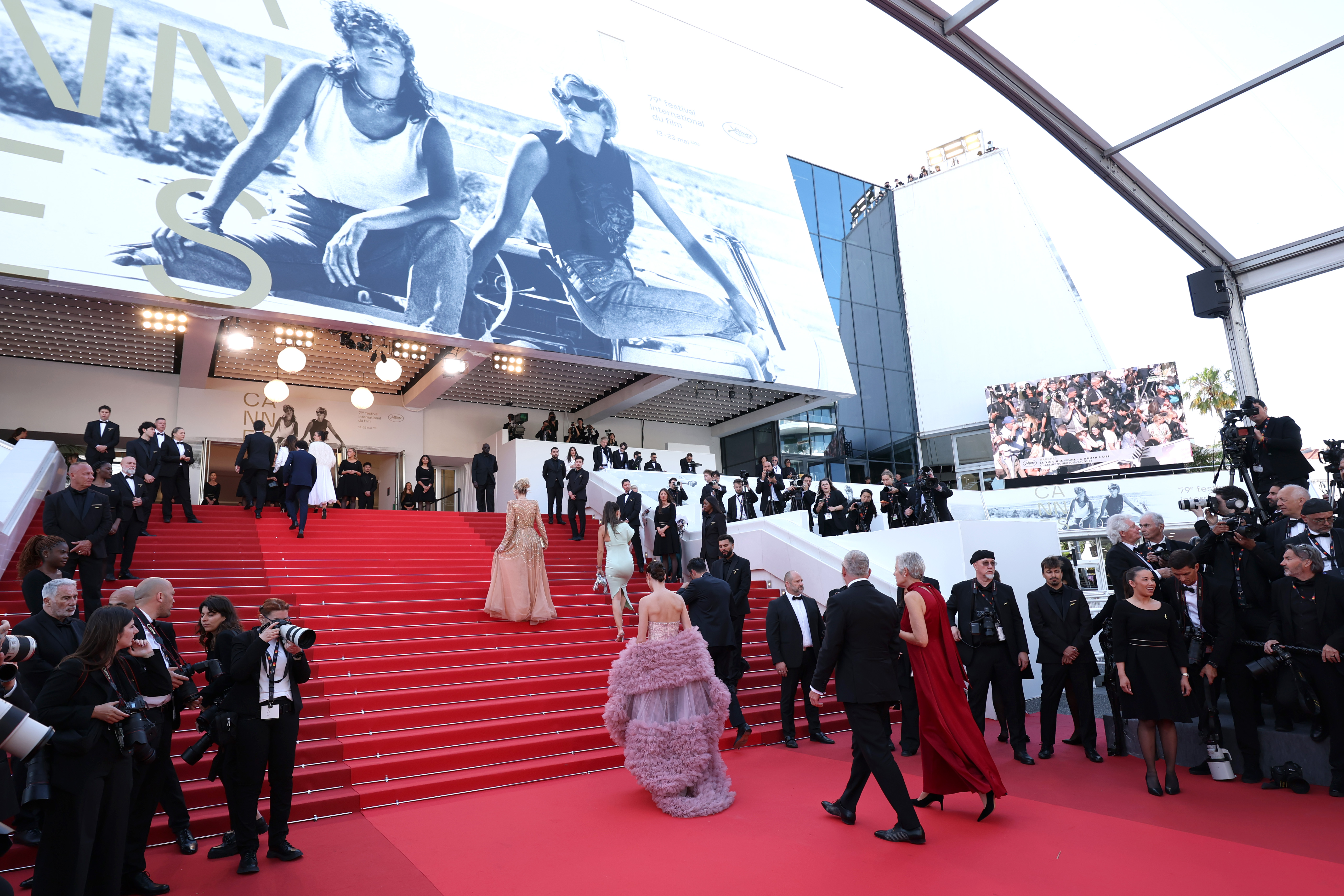 A wide view of the Cannes red carpet steps as guests, photographers, and attendees gather outside the Grand Théâtre Lumière during the festival | Source: Getty Images