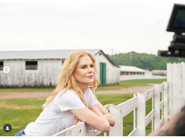 A behind-the-scenes moment captures a quiet pause by the white paddock fence, with long barn structures and rolling greenery stretching out behind — highlighting the rustic charm of the working property. From a post dated October 5, 2021. | Source: Instagram/nicolekidman