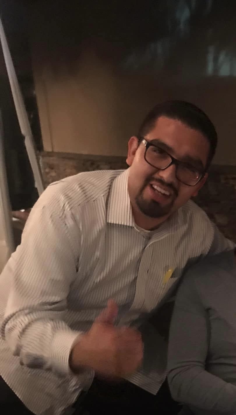 The former child star smiles and gives a thumbs-up in a casual photo, wearing glasses and a striped shirt — a rare glimpse of his life away from Hollywood. | Source: Private Facebook Page.