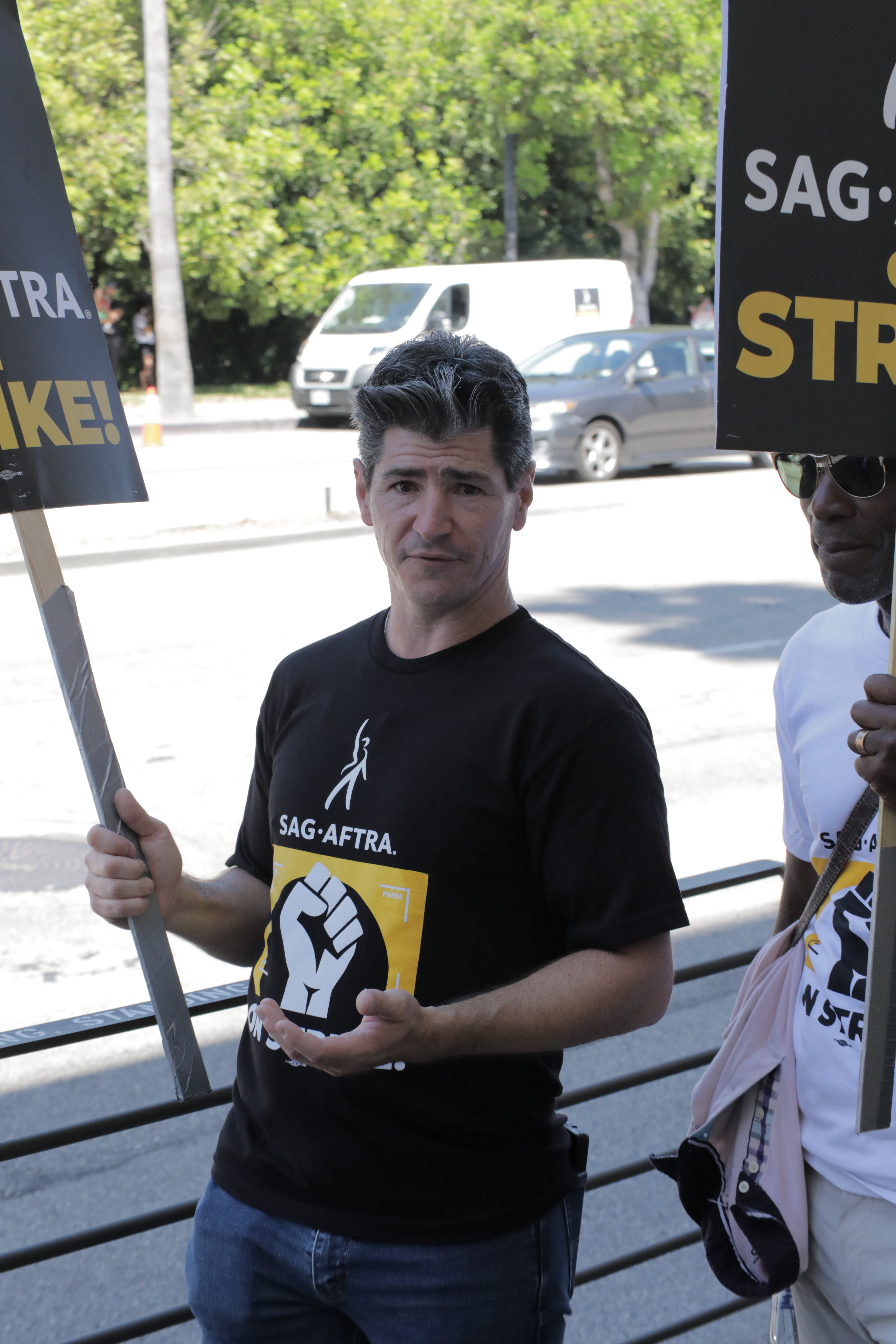 Michael Fishman stood in solidarity with his fellow actors and writers during industry labor actions. In this photo, he walked the picket line outside Warner Bros. Studios in support of the SAG-AFTRA and WGA strike on August 3, 2023, in Burbank, California. | Source: Getty Images   Getty Images