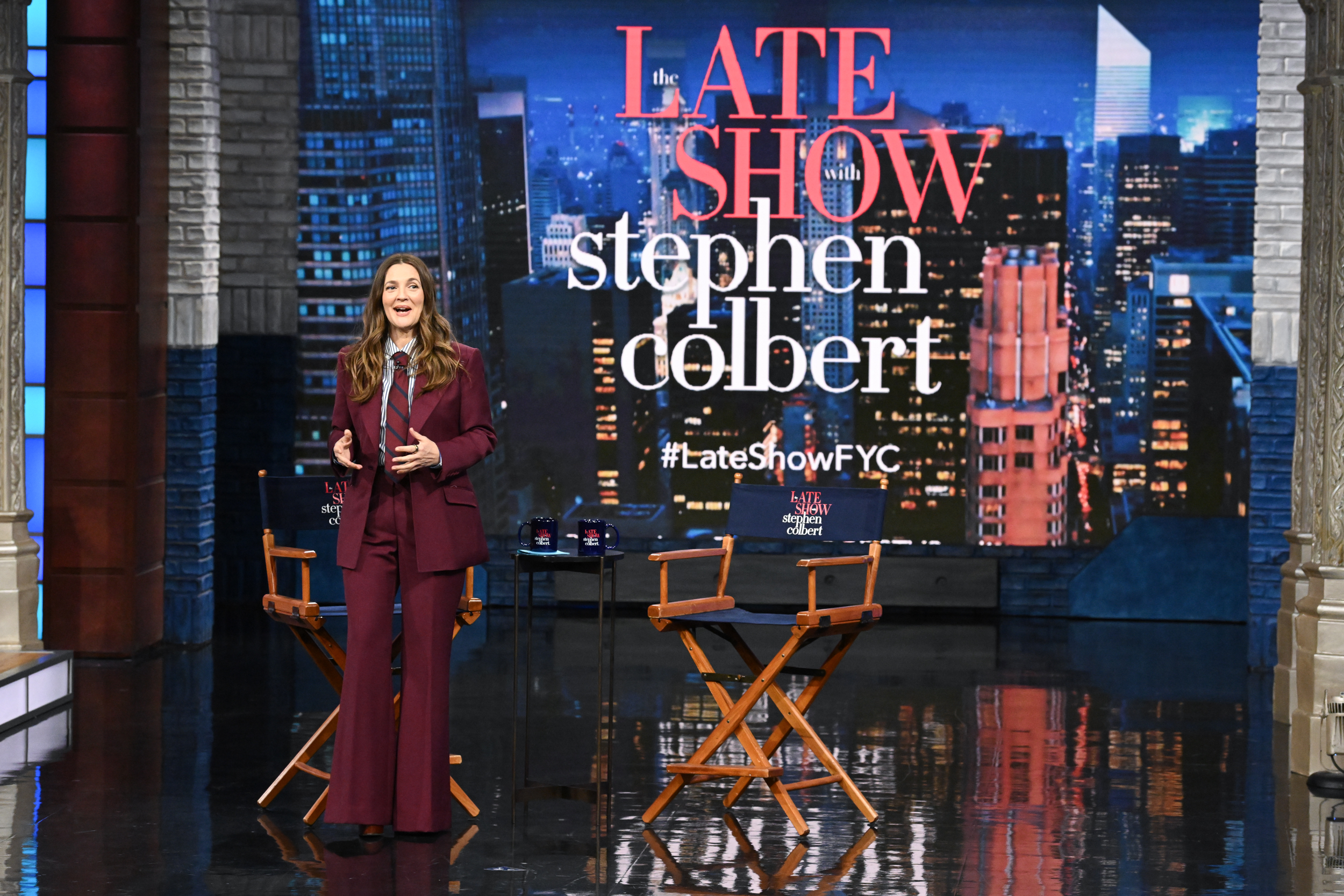 Drew Barrymore in a crisp burgundy suit while moderating "The Late Show with Stephen Colbert" on May 1, 2025.