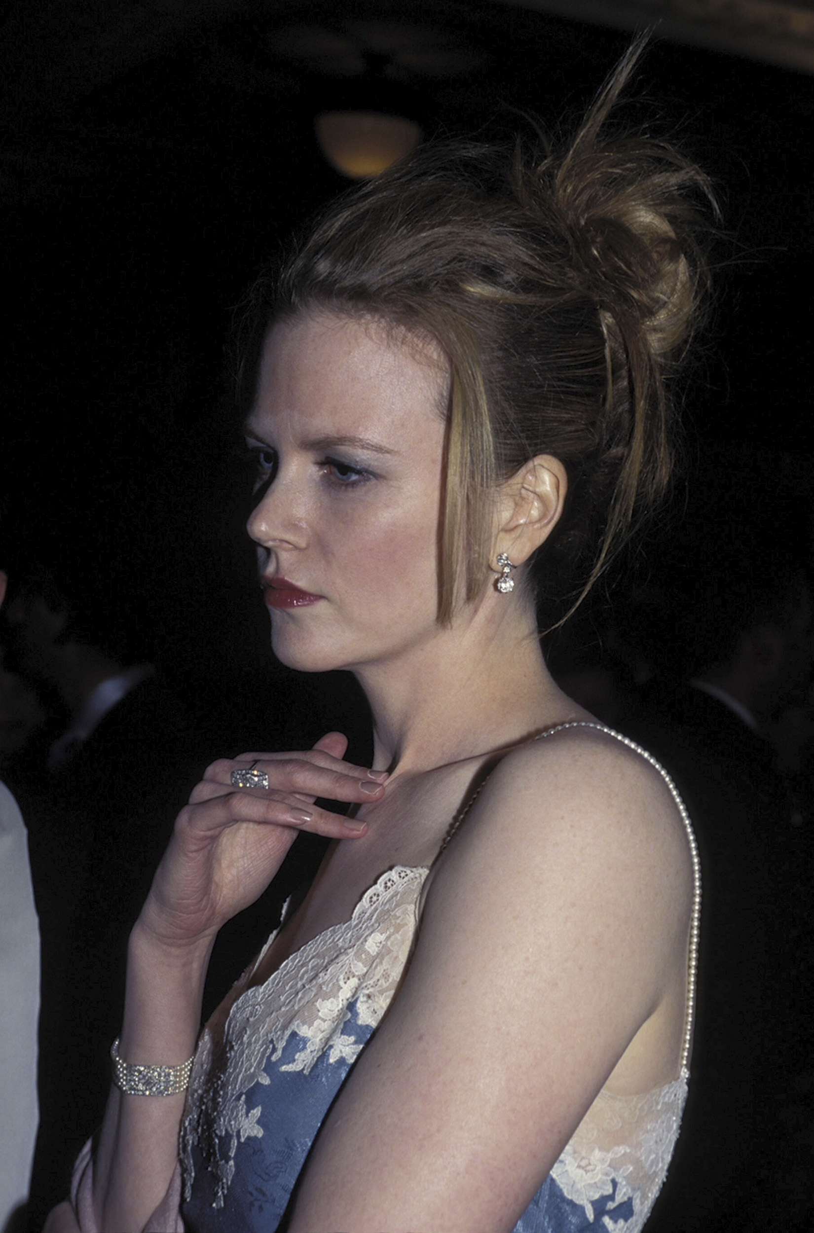 Nicole Kidman at the AFI Awards in Sydney with her hair styled in a sleek updo. The natural curls are completely smoothed out, with a few straightened strands left loose at the front, signaling a clear move away from her natural texture. | Source: Getty Images