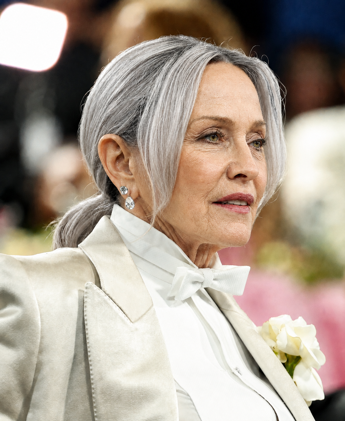 The AI-altered version preserves Madonna's white formal ensemble, jewelry and pose while reimagining her with gray hair and changes to her facial and neck appearance. | Source: Chat GPT