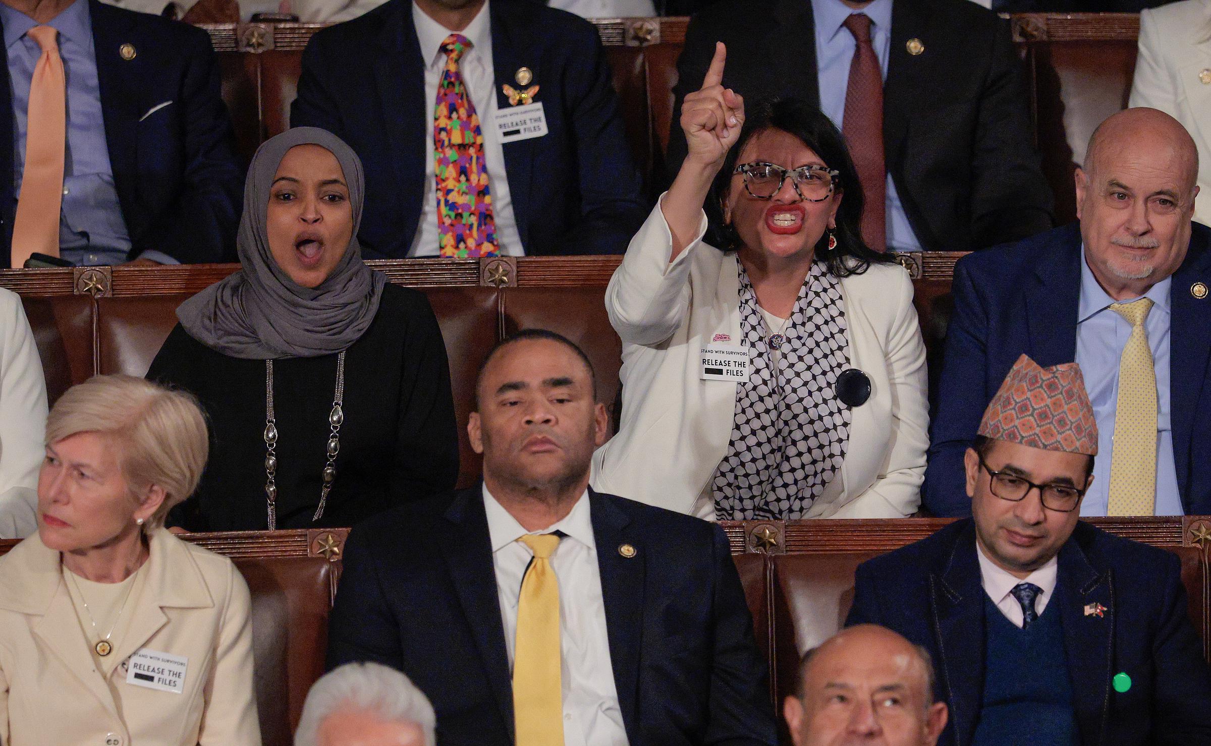 Rep. Ilhan Omar and Rep. Rashida Tlaib shout as President Donald Trump delivers his State of the Union address in Washington, DC, on February 24, 2026. | Source: Getty Images