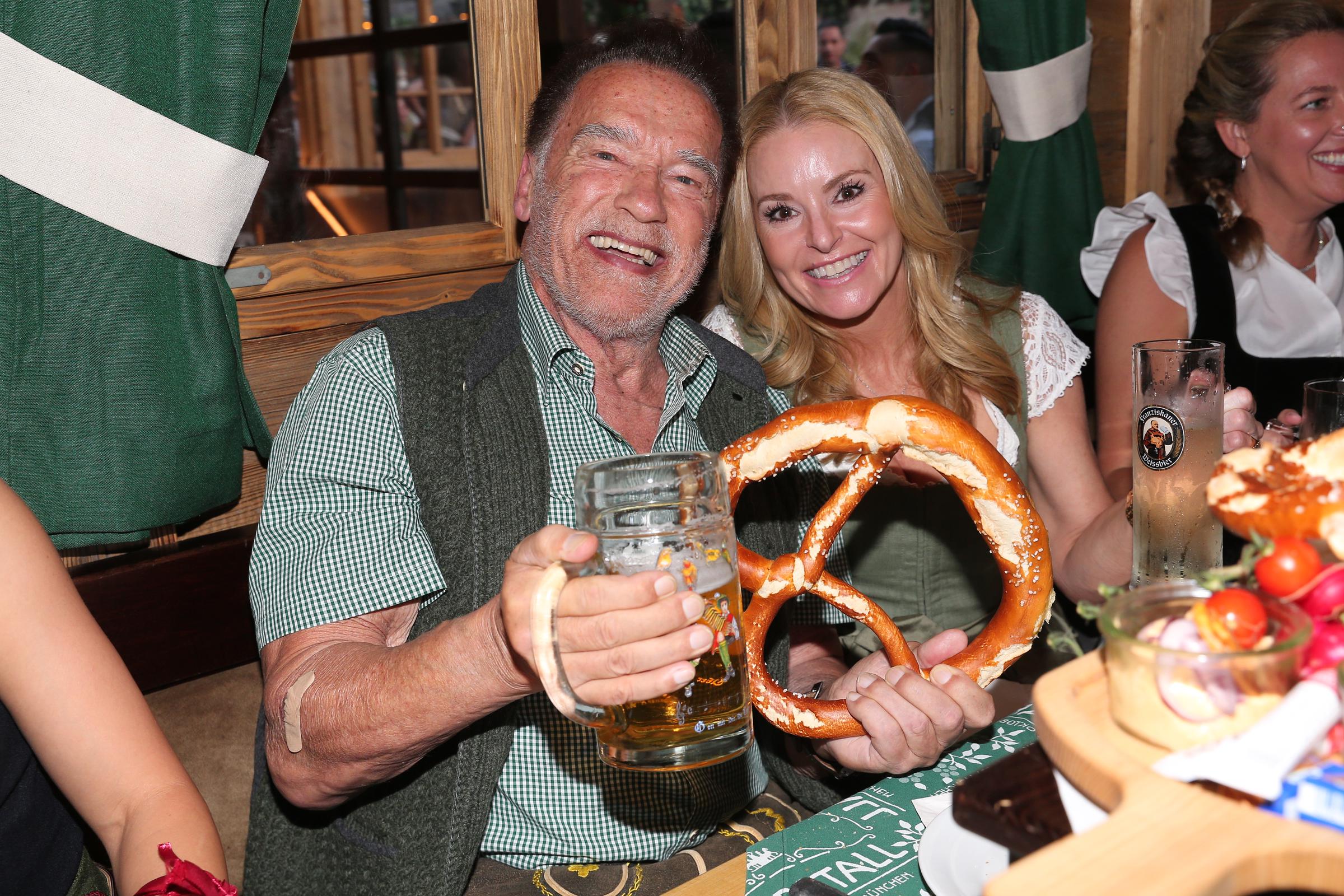 Arnold Schwarzenegger and Heather Milligan attend the opening day of the Munich Oktoberfest on September 21, 2024 | Source: Getty Images