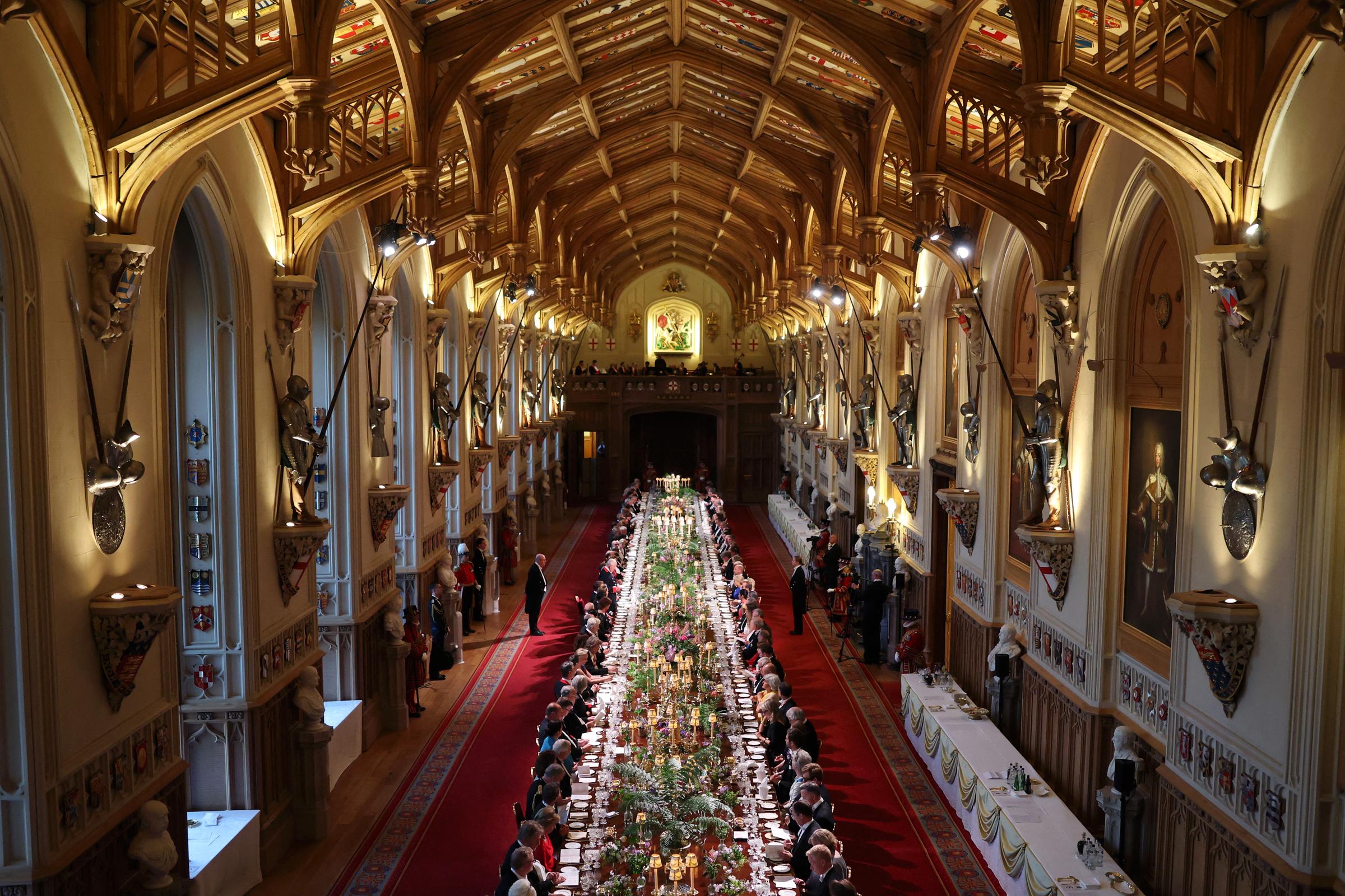 Dignitaries, royalties, and international diplomacies are seated at the long table as Britain's King Charles III delivers a speech during the state banquet hosted at Windsor Castle, west of London.