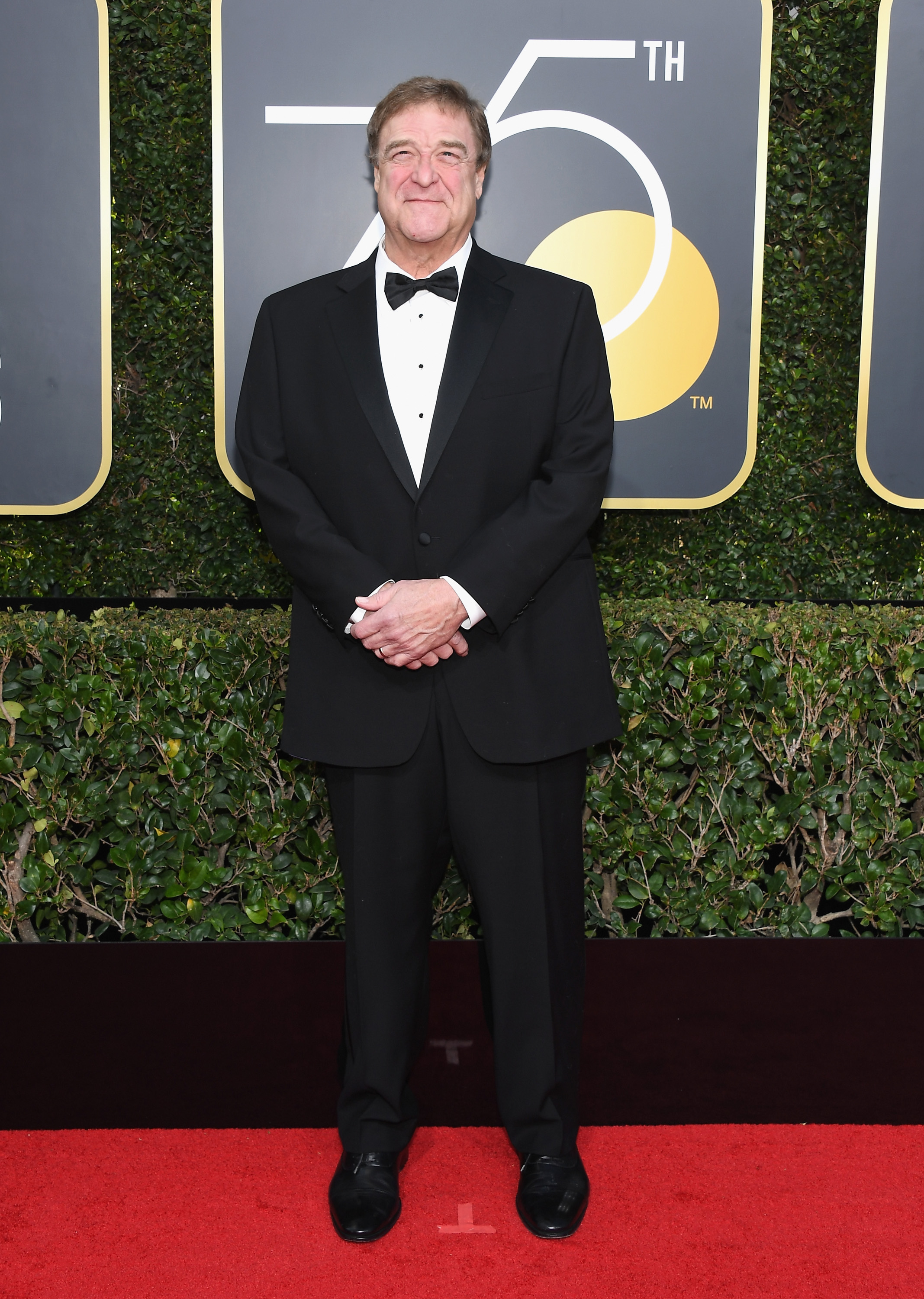 For the annual Golden Globe Awards, Goodman appeared on the red carpet in a simple but classy white shirt tucked into a black suit. He wore a big smile with his palm on top of the other.