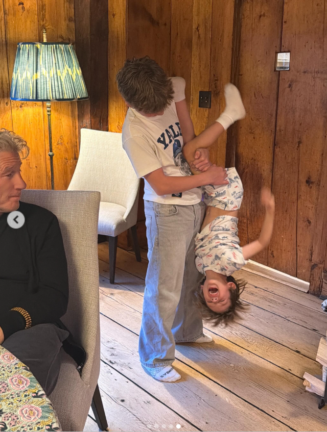 One of Richard Gere and Alejandra Silva’s sons laughs while being playfully swung upside by his brother. | Source: Instagram/alejandragere