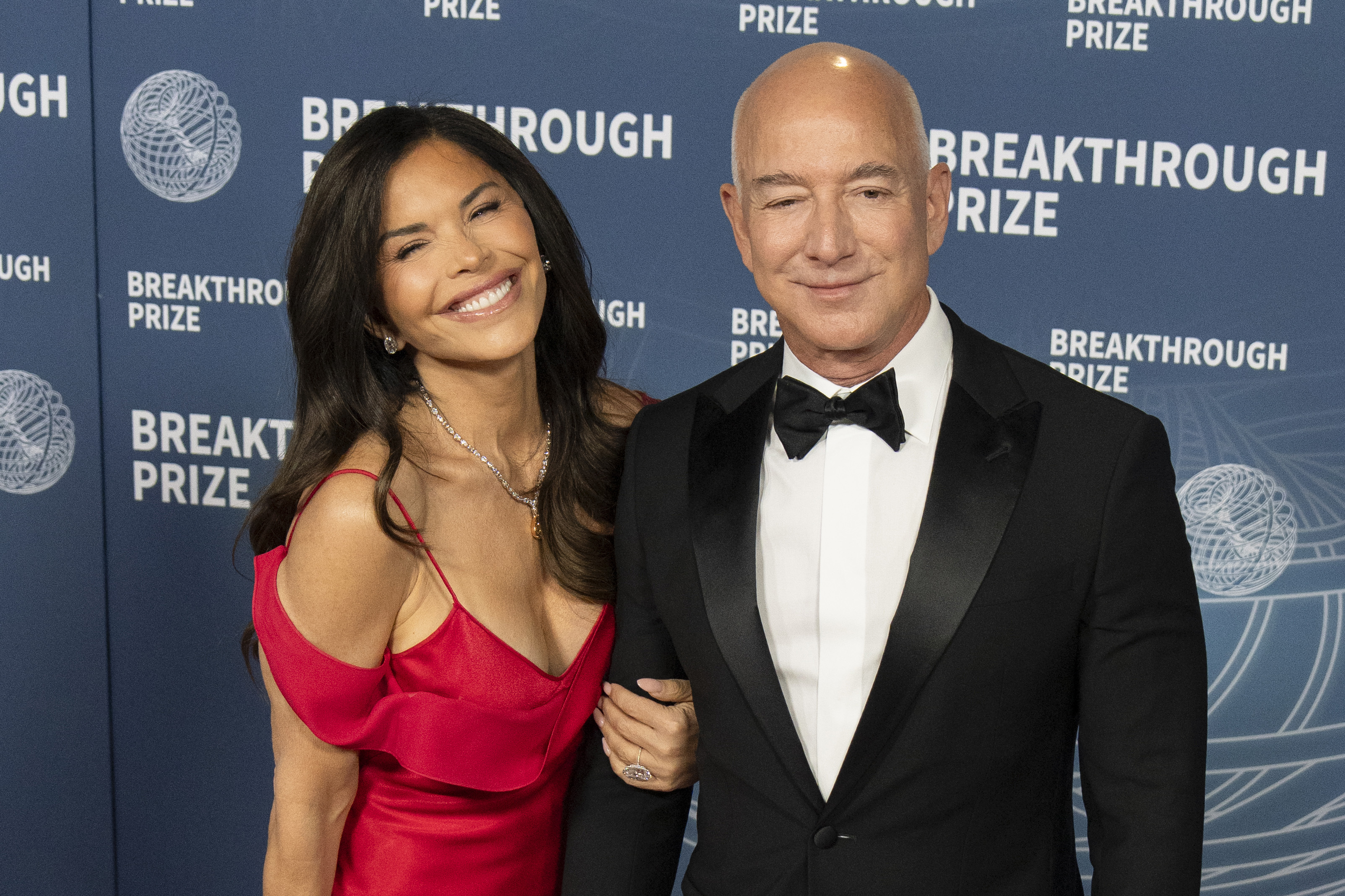 Lauren Sanchez beams beside Jeff Bezos as they arrive at the 2025 Breakthrough Prize Ceremony held at Barker Hangar on April 5, 2025, in Santa Monica, California | Source: Getty Images