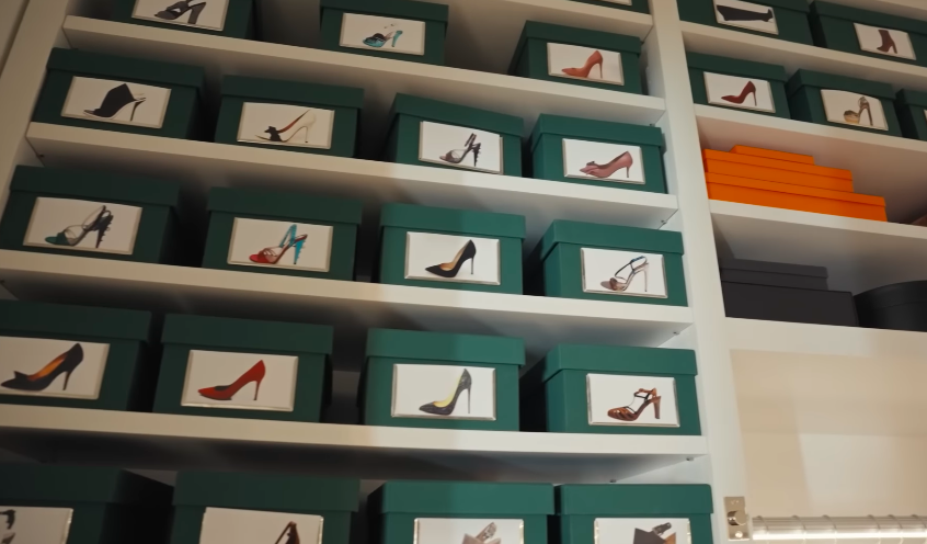 Kelly's shoe storage looks like a private archive. The labeled boxes turn fashion into a system. | Source: YouTube/Architectural Digest