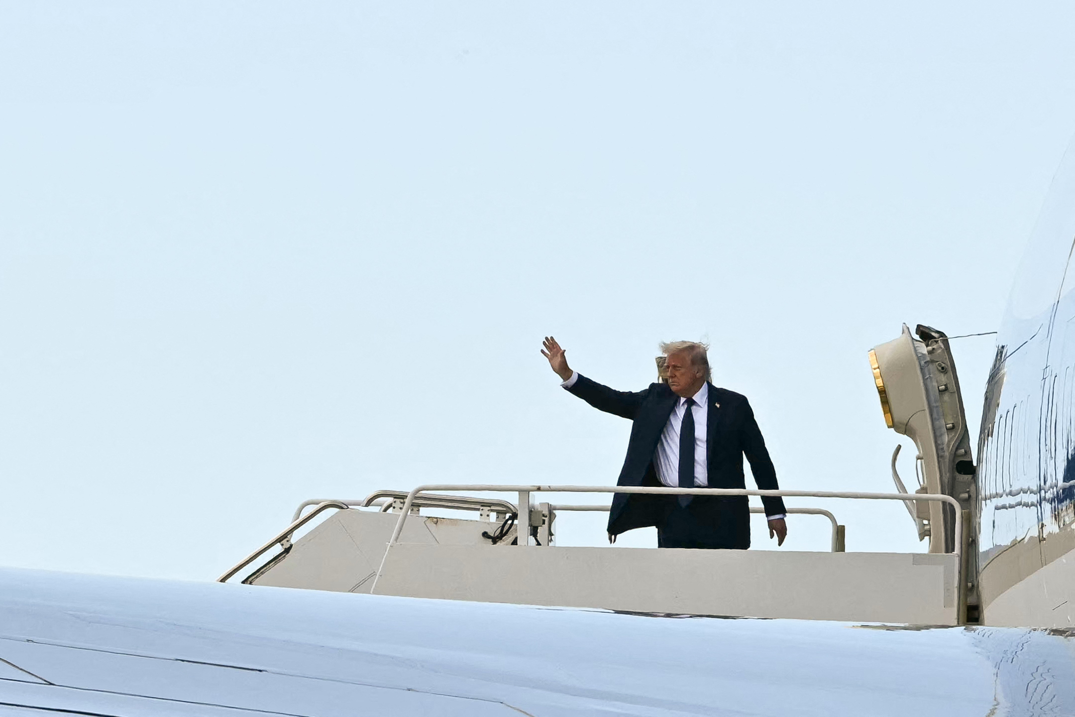 Donald waves to onlookers as he boards Air Force One at Leonardo da Vinci International Airport in Fiumicino after attending the funeral ceremony of Pope Francis at the Vatican.
