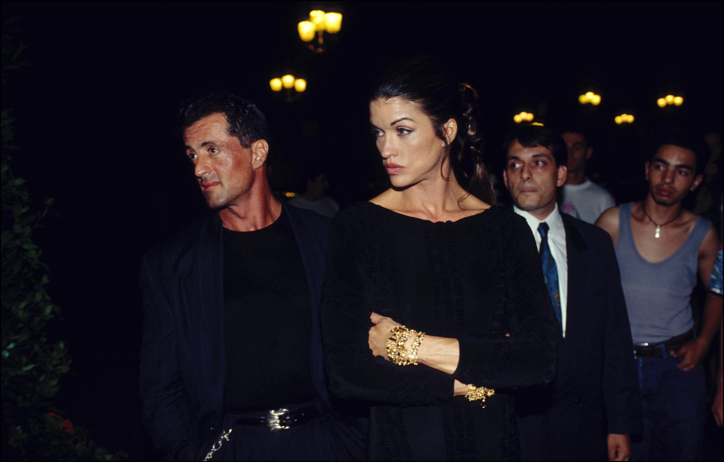 Sylvester Stallone and a date leaving Gianni Versace's fashion show on July 1, 1994, in Paris, France. | Source: Getty Images