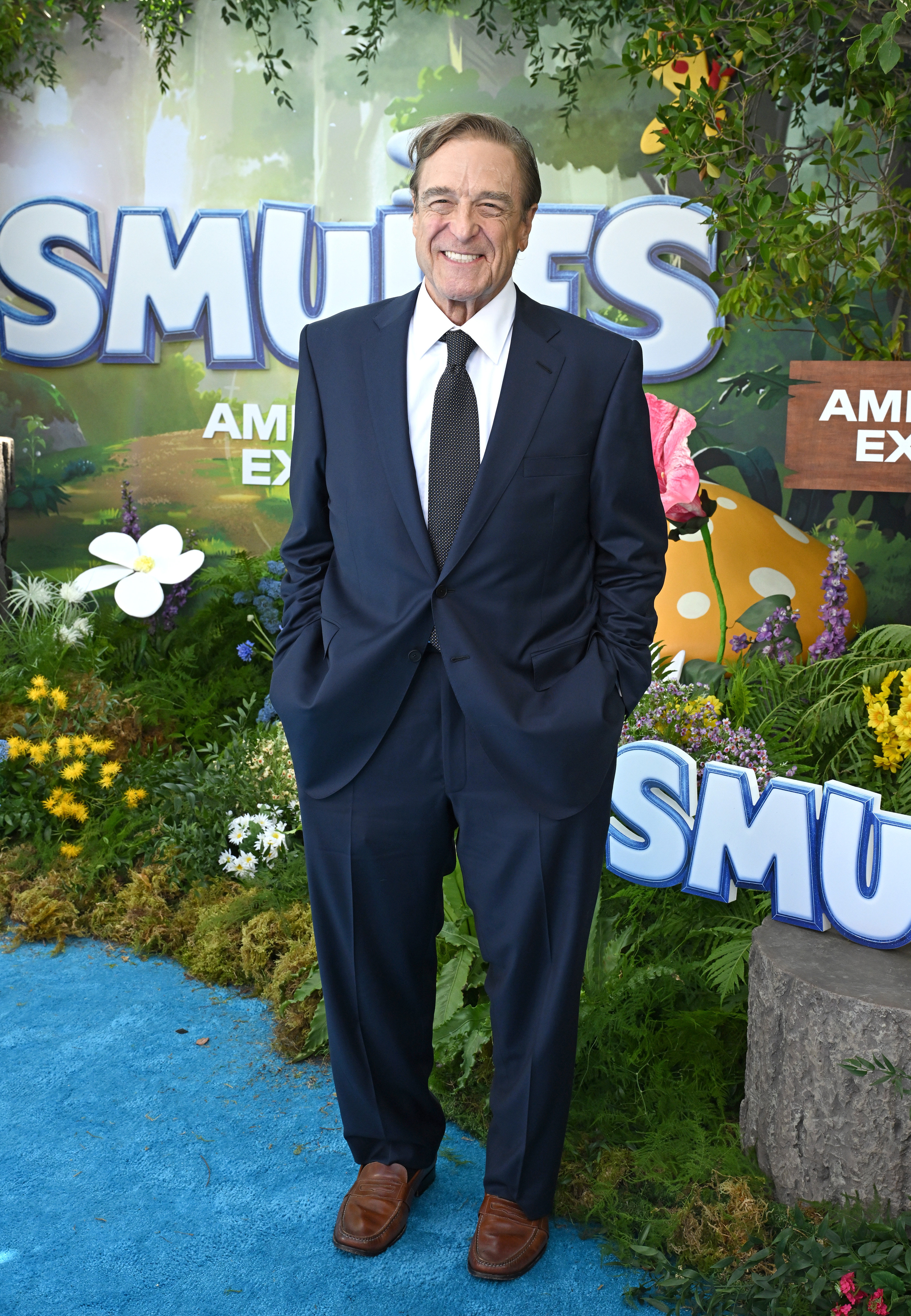 With a big grin and happy smile, Goodman showcased his slimmer physique on the "The Smurfs Movie" premiere in 2025 held in Los Angeles. He exuded confidence in his ensemble as he posed with both hands in his suit pockets.