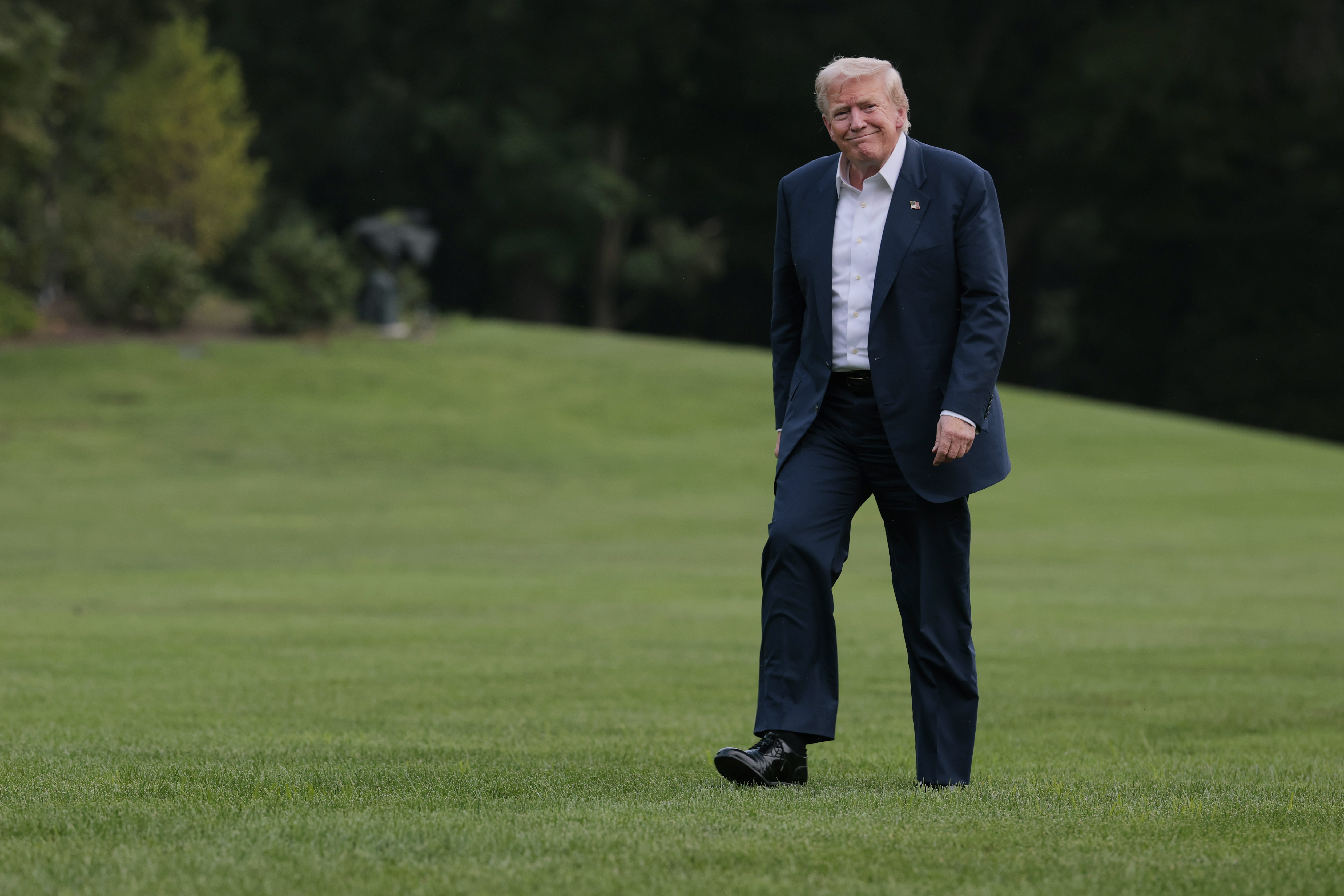 Donald Trump walks across the South Lawn of the White House after returning on Marine One on July 29, 2025 in Washington, DC | Source: Getty Images