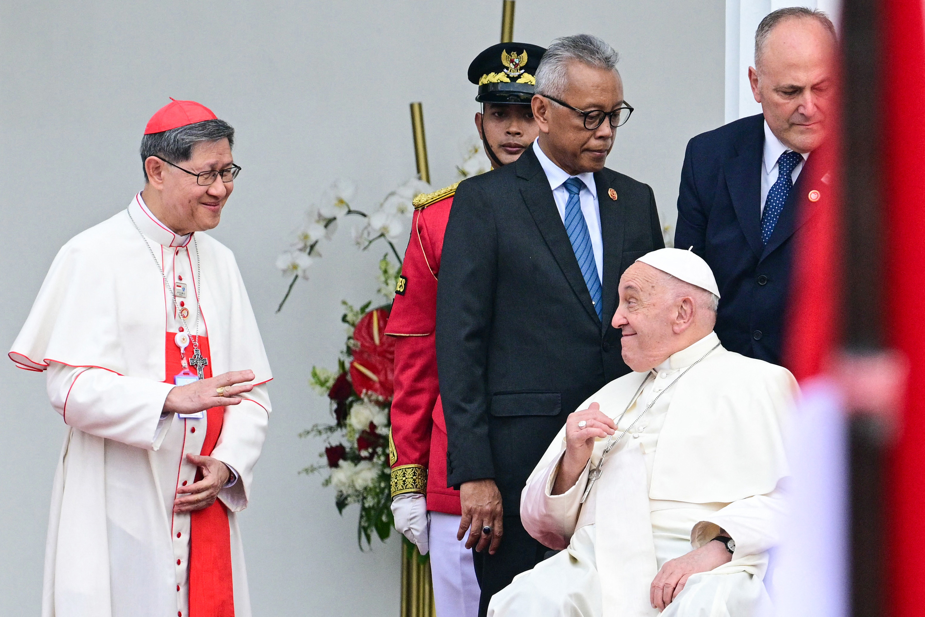 Pope Francis (2nd R) waves at Philippine Cardinal Luis Antonio Tagle (L) during a ceremonial welcome at the Presidential Palace in Jakarta on September 4, 2024 | Source: Getty Images