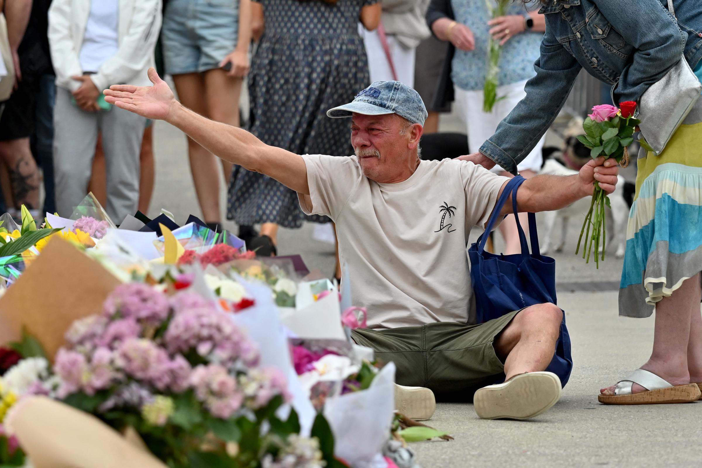 A mourner reacts as he pays a floral tribute at the Bondi Pavilion in Sydney on December 15, 2025. | Source: Getty Images